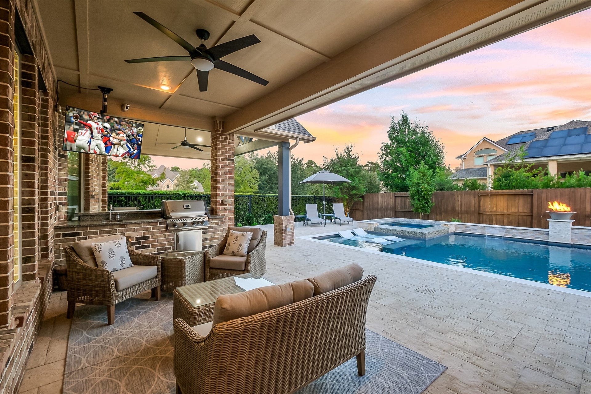 If you love entertaining or feeling like youre on vacation in your back yard, this custom outdoor living space is for you. Featuring a built-in kitchen with a grill and sink, mounted TV, surround sound, ceiling fans and all surrounded by beautiful landscaping and landscape lighting, youll love this extension of your entertaining space.