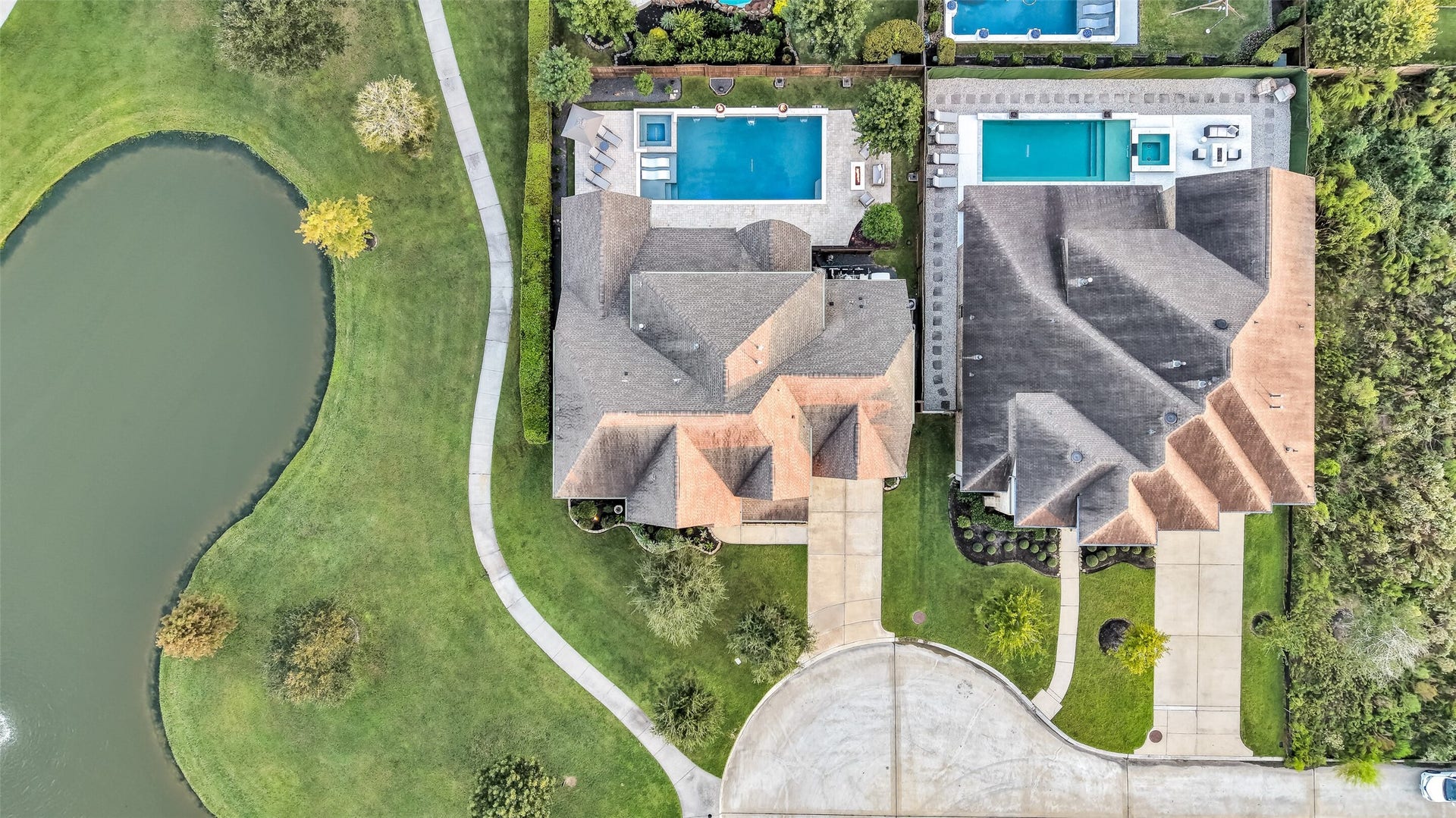 This top-down aerial view highlights this great location right next to the neighborhood pond and trails with lush landscaping and tucked along a tree-lined cul-de-sac, with no overhead power lines in sight.