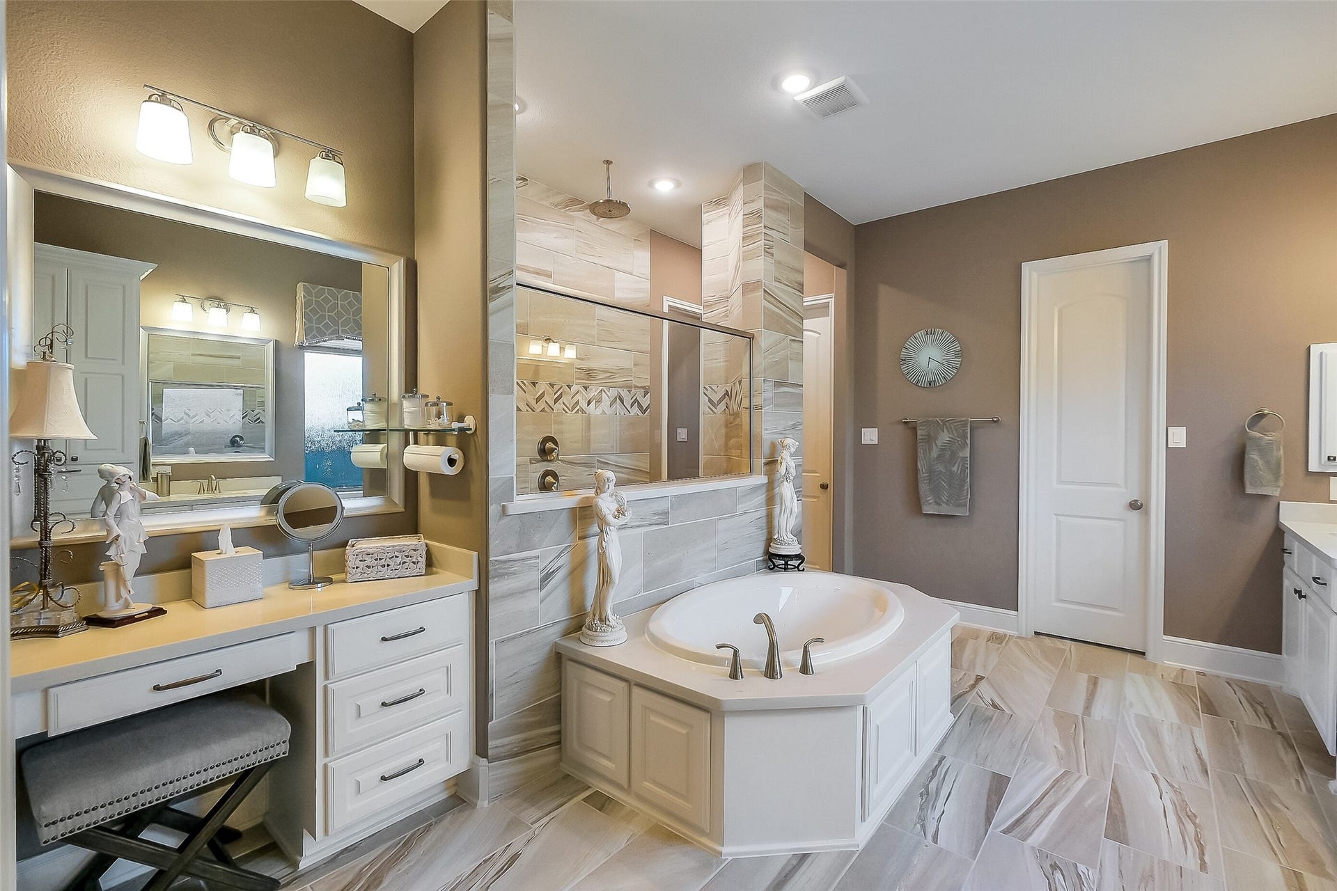 This angle of the primary bathroom highlights the vanity area. You'll appreciate TWO WALK IN CLOSETS!