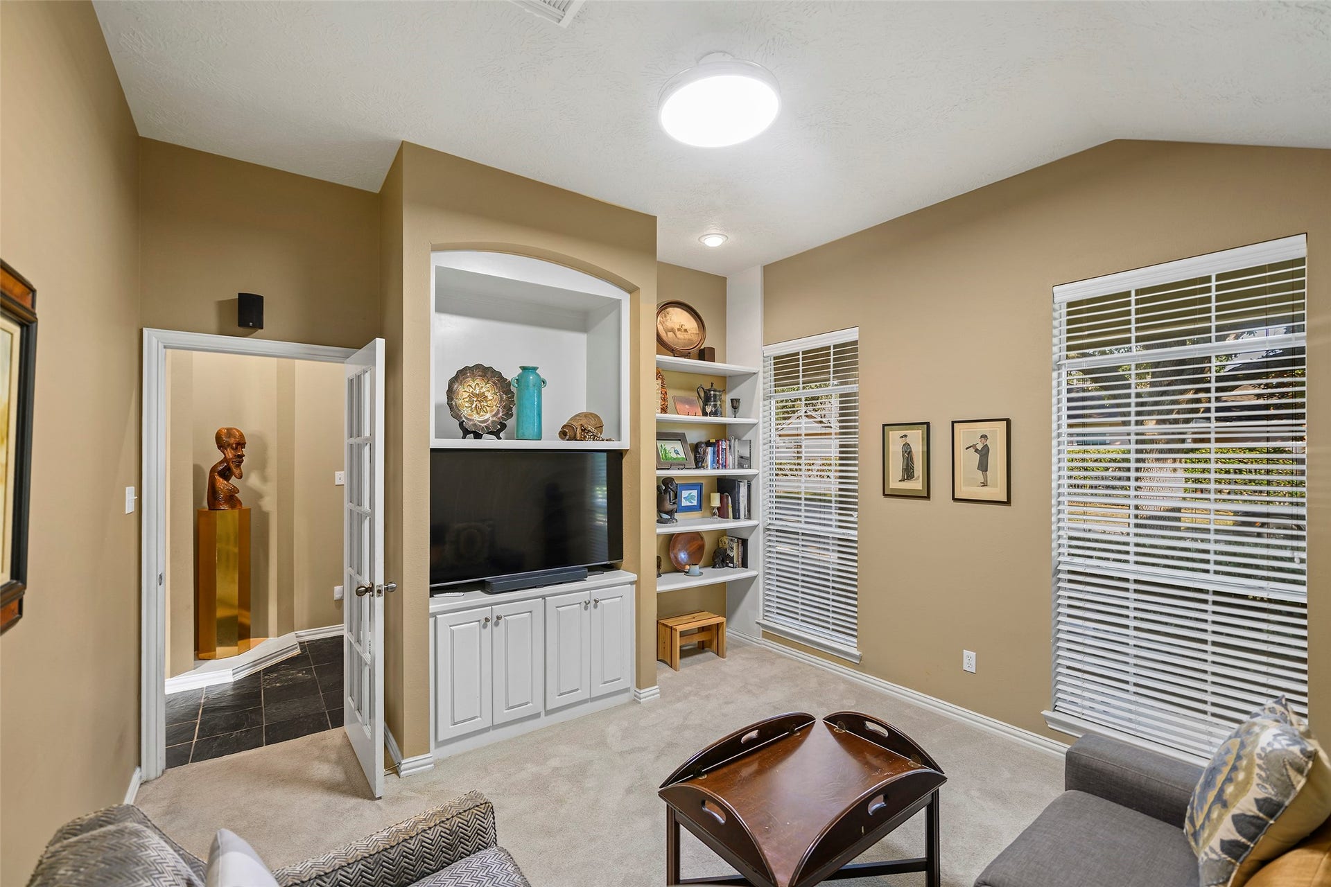 As you enter the home the first room to your left is the media room with built in shelfs.