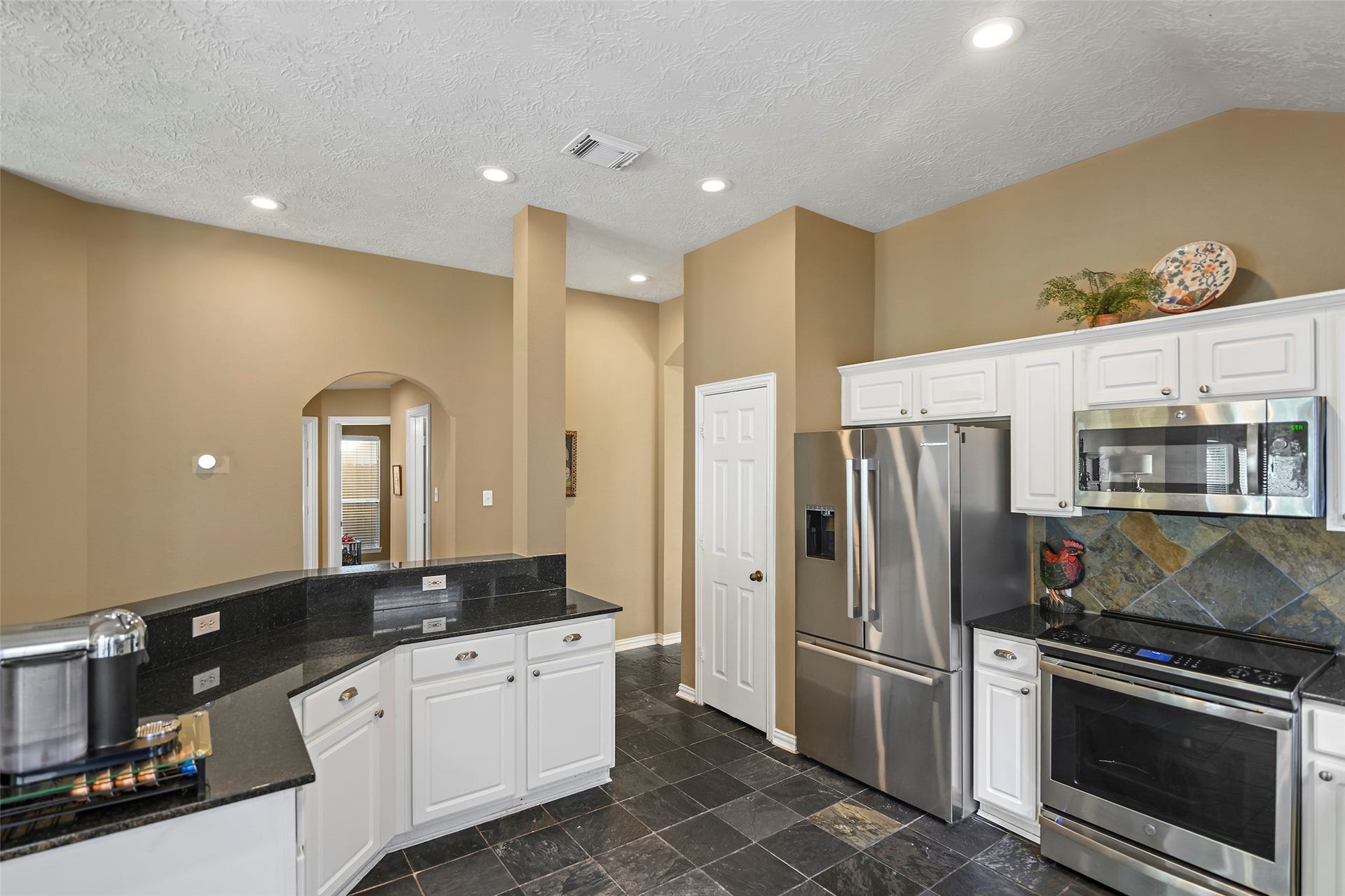 This view of the kitchen shows the island which features pull out shelving for easy acces to your pans or appliances.