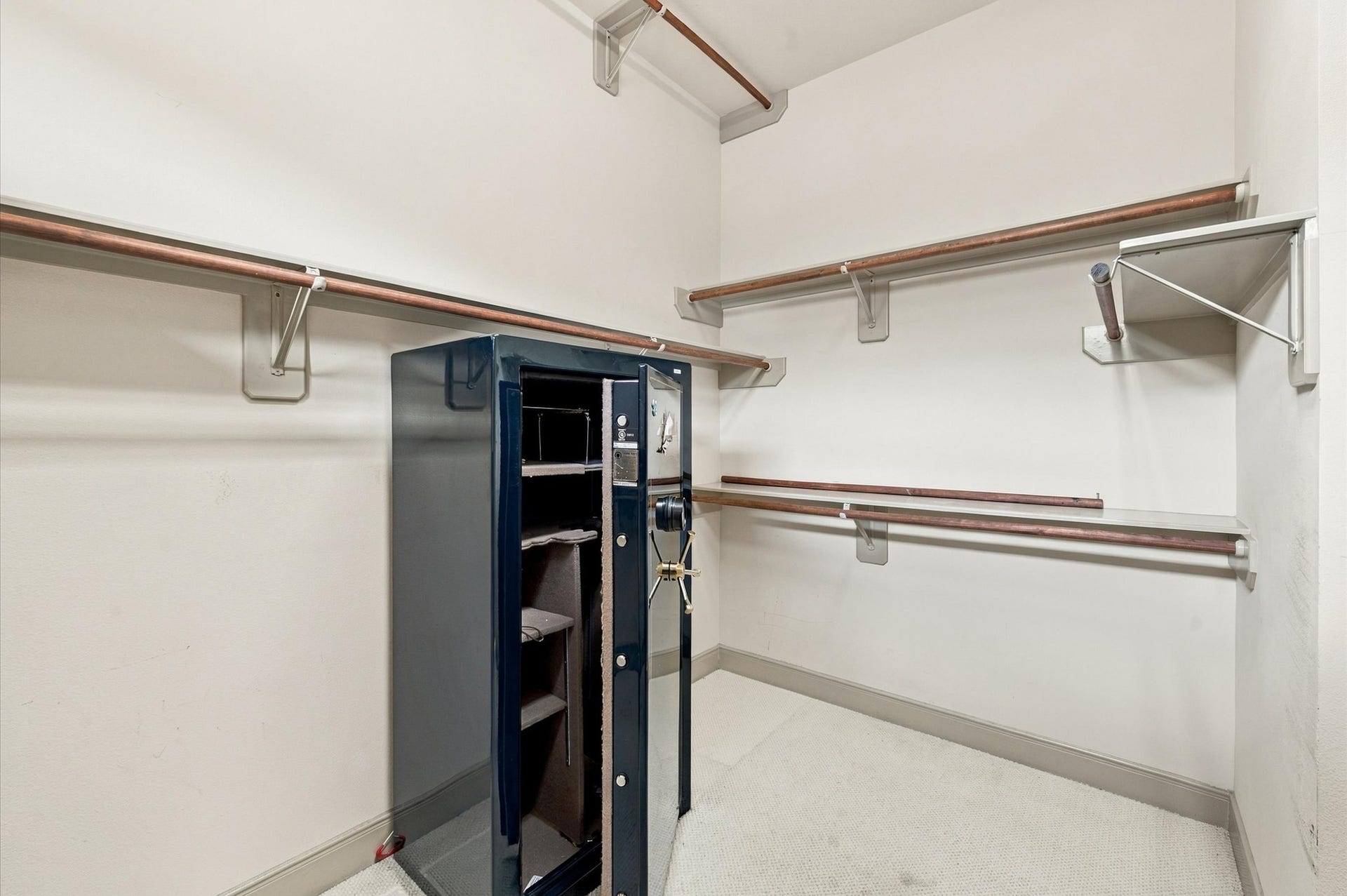 4427 Shady River, Missouri City, TX 77459 Spacious walk-in closet featuring ample shelving and hanging space, complete with a secure safe for your valuables.