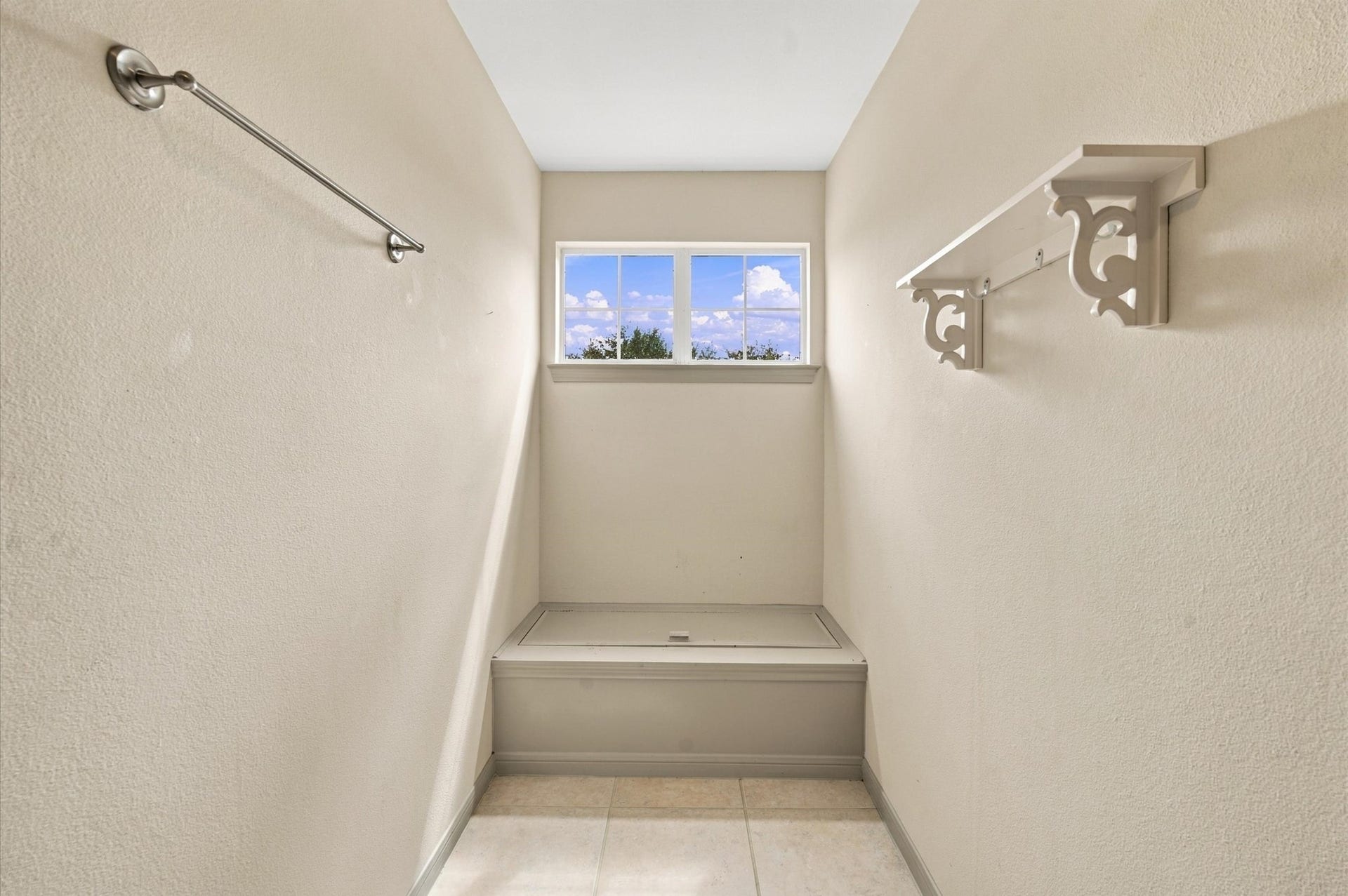 4427 Shady River, Missouri City, TX 77459 Bright utility space featuring a small window for natural light, with practical shelving and a bench area for convenience.