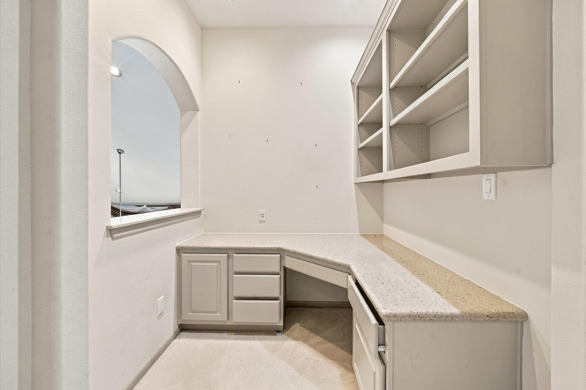 4427 Shady River, Missouri City, TX 77459 Charming study nook with built-in shelving and a spacious L-shaped desk, perfect for a home office or study area.