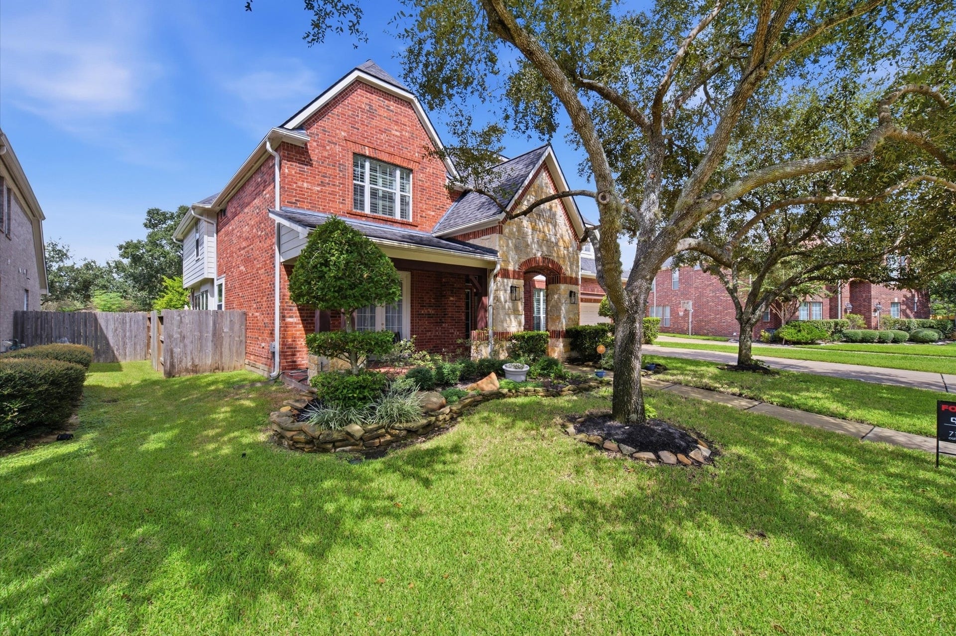 4427 Shady River, Missouri City, TX 77459 Charming brick home with a lush front yard, mature trees, and inviting curb appeal.