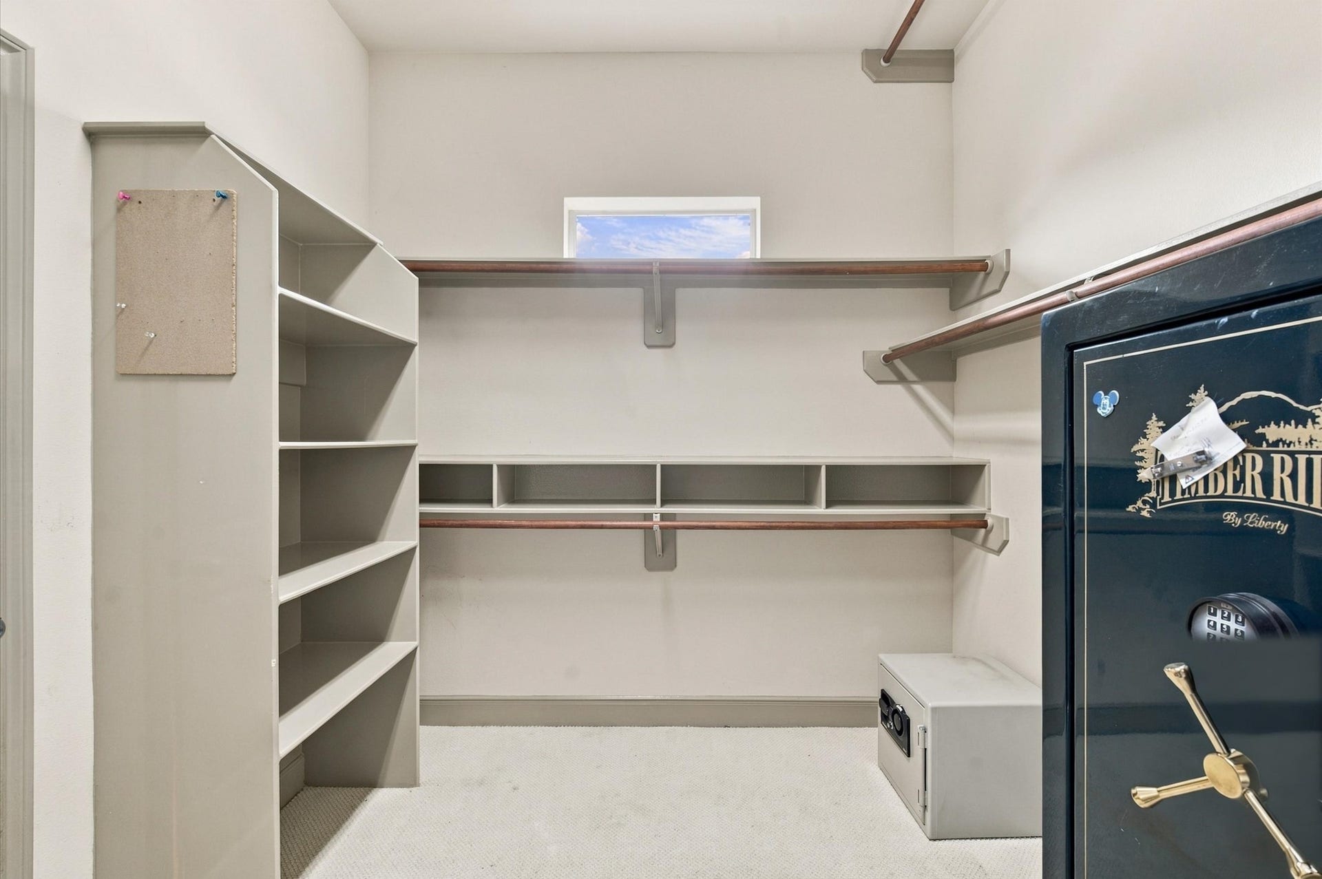 4427 Shady River, Missouri City, TX 77459 Spacious walk-in closet with built-in shelving and ample hanging space, featuring a secure safe for valuables.