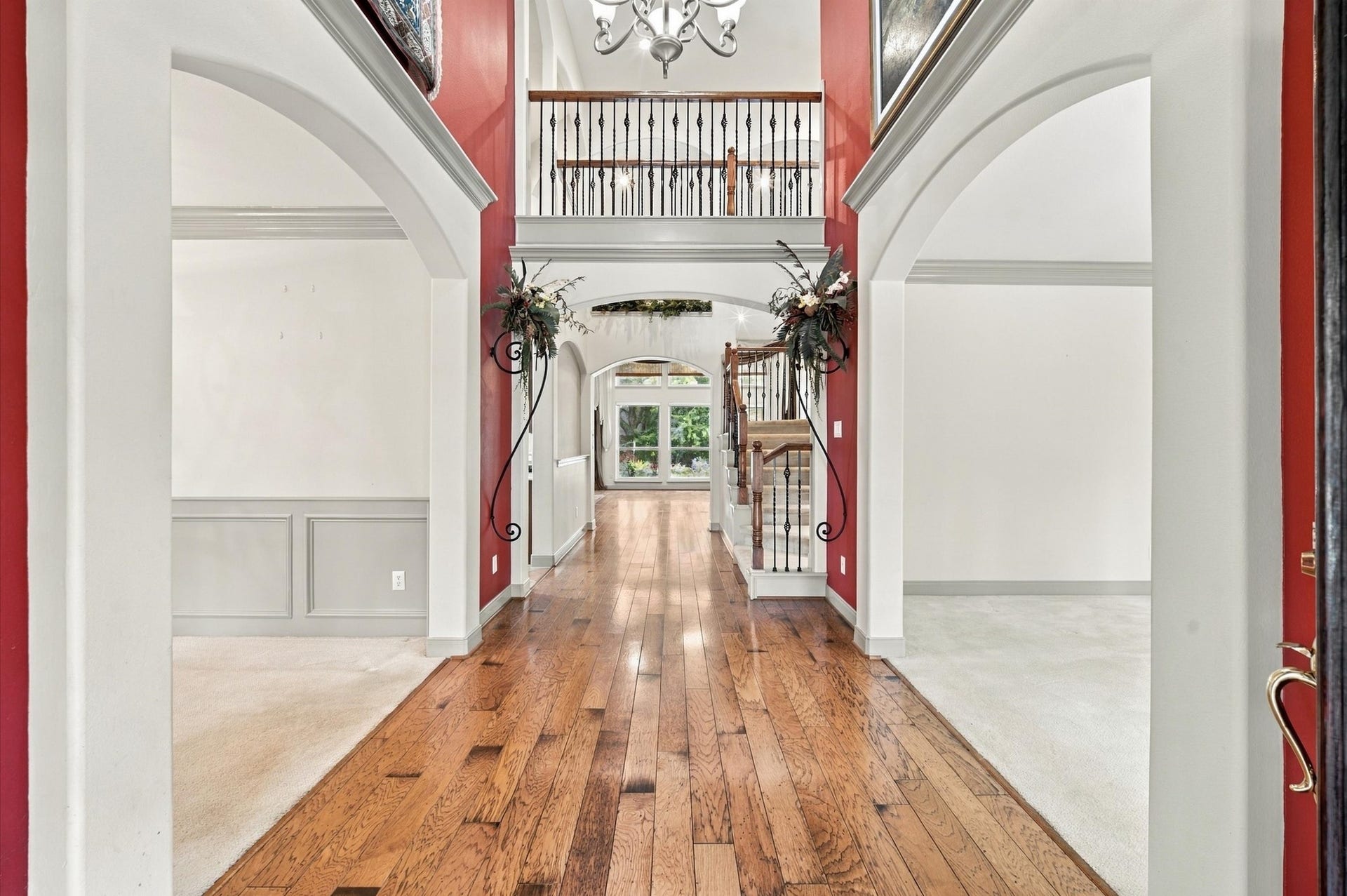 4427 Shady River, Missouri City, TX 77459 Stunning entryway with elegant hardwood floors, soaring ceilings, and a beautiful staircase, offering a grand first impression.