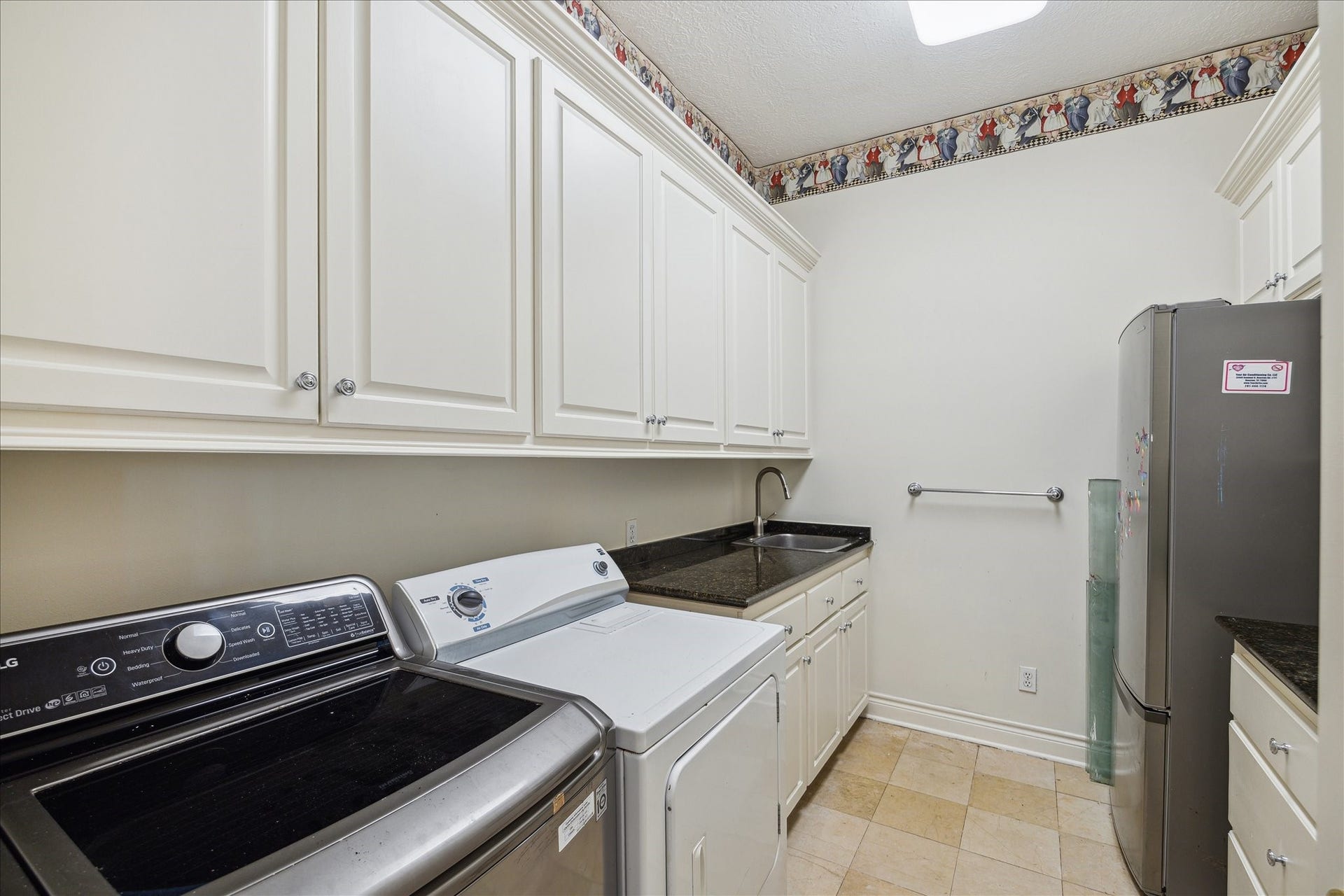 38 Scotsmoor Court, Sugar Land, TX 77479 Loads of room for laundry and space to stage an event with it's own full size refrigerator.
