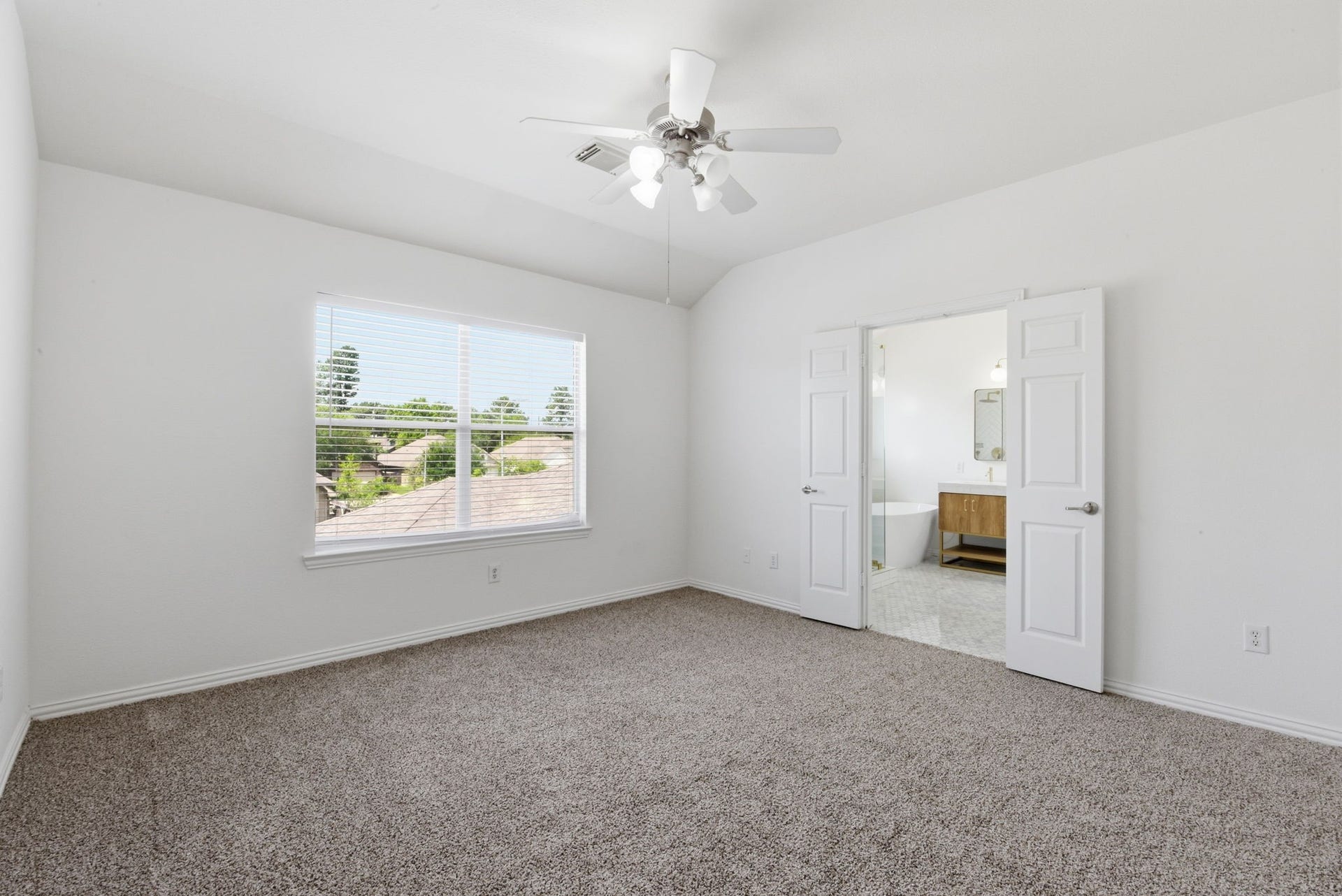 16023 Powder Springs Lane, Houston, TX 77070 This large primary bedroom is upstairs. It has fresh paint, recently replaced carpet, updated ceiling fan, white faux wood blinds.