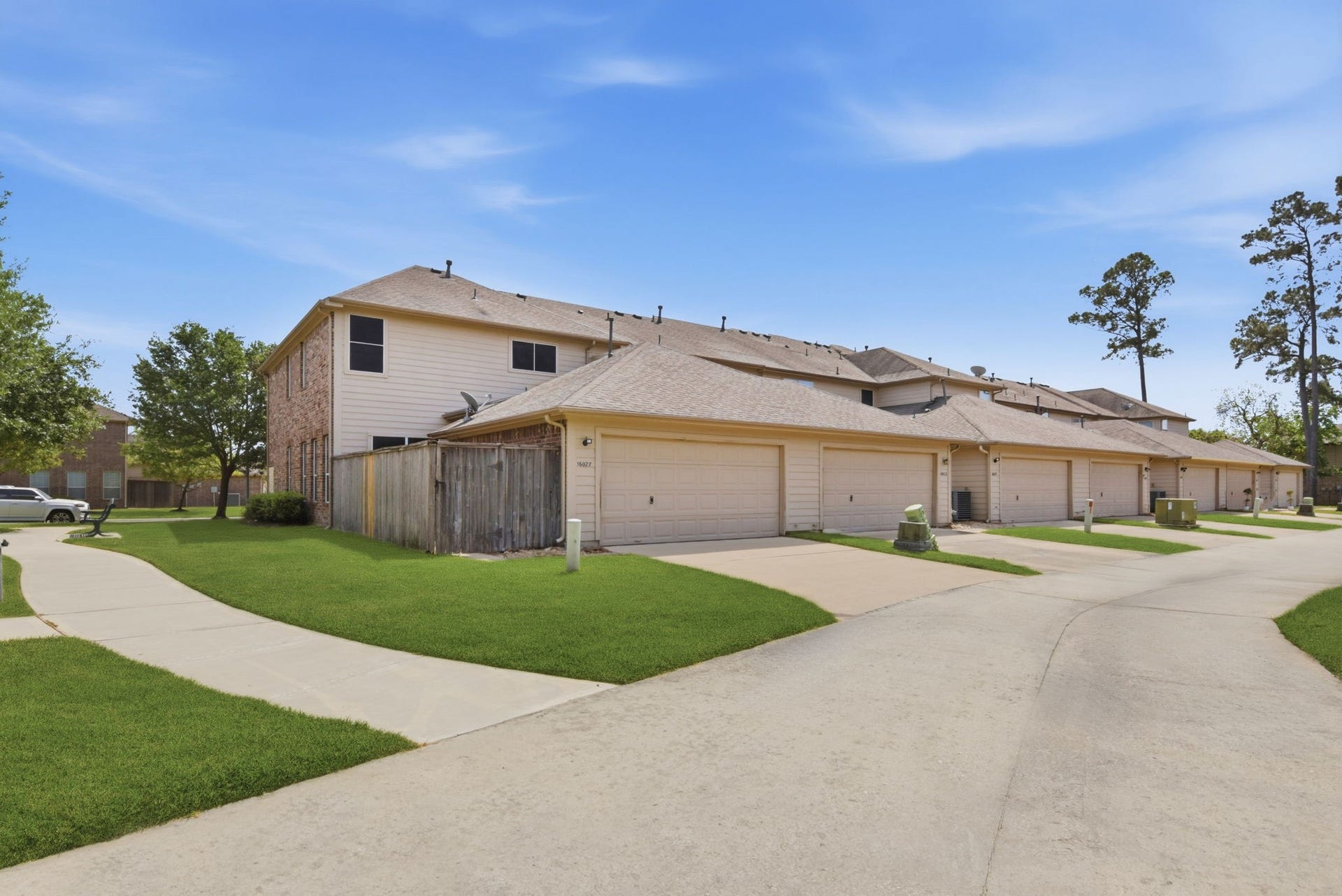 16023 Powder Springs Lane, Houston, TX 77070 A look from down the back street area. Lots of walkable green space right around the townhome.