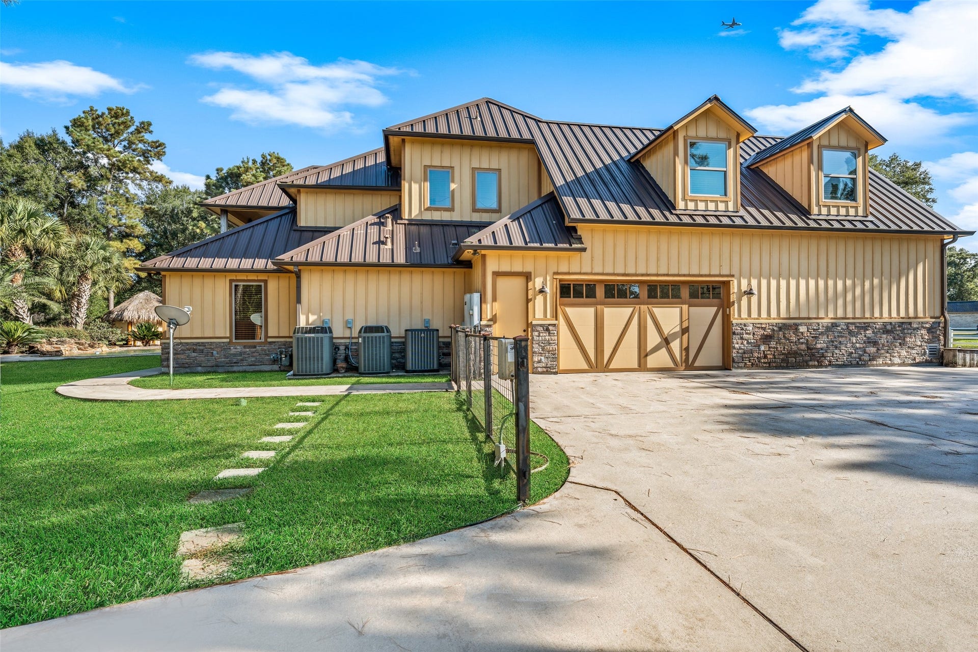 Expansive side view showcases a convenient second garage entrance and a full-house gas generator for peace of mind.