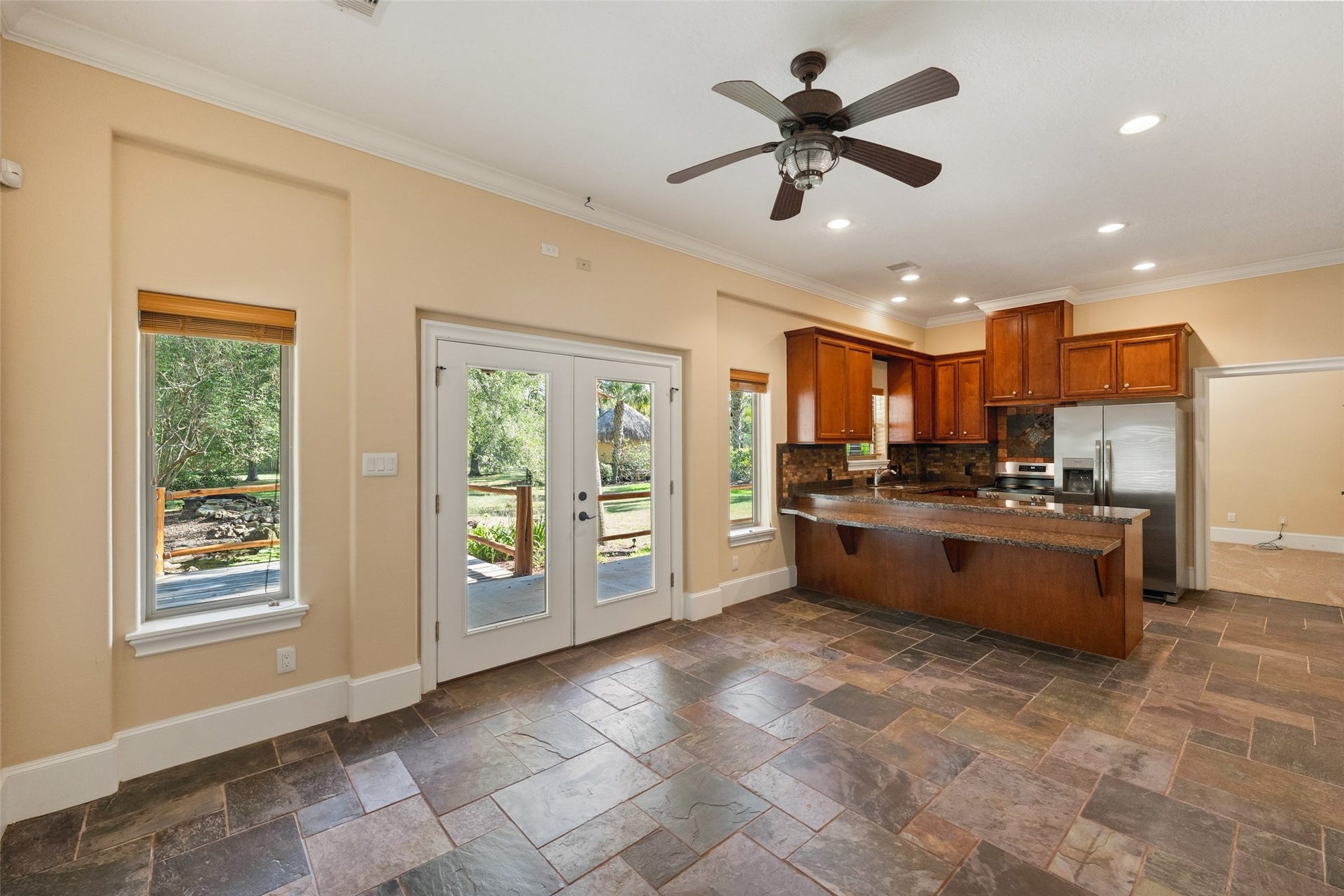 Charming guest house featuring a cozy family room, a full kitchen with brand new appliances, and elegant slate floors.