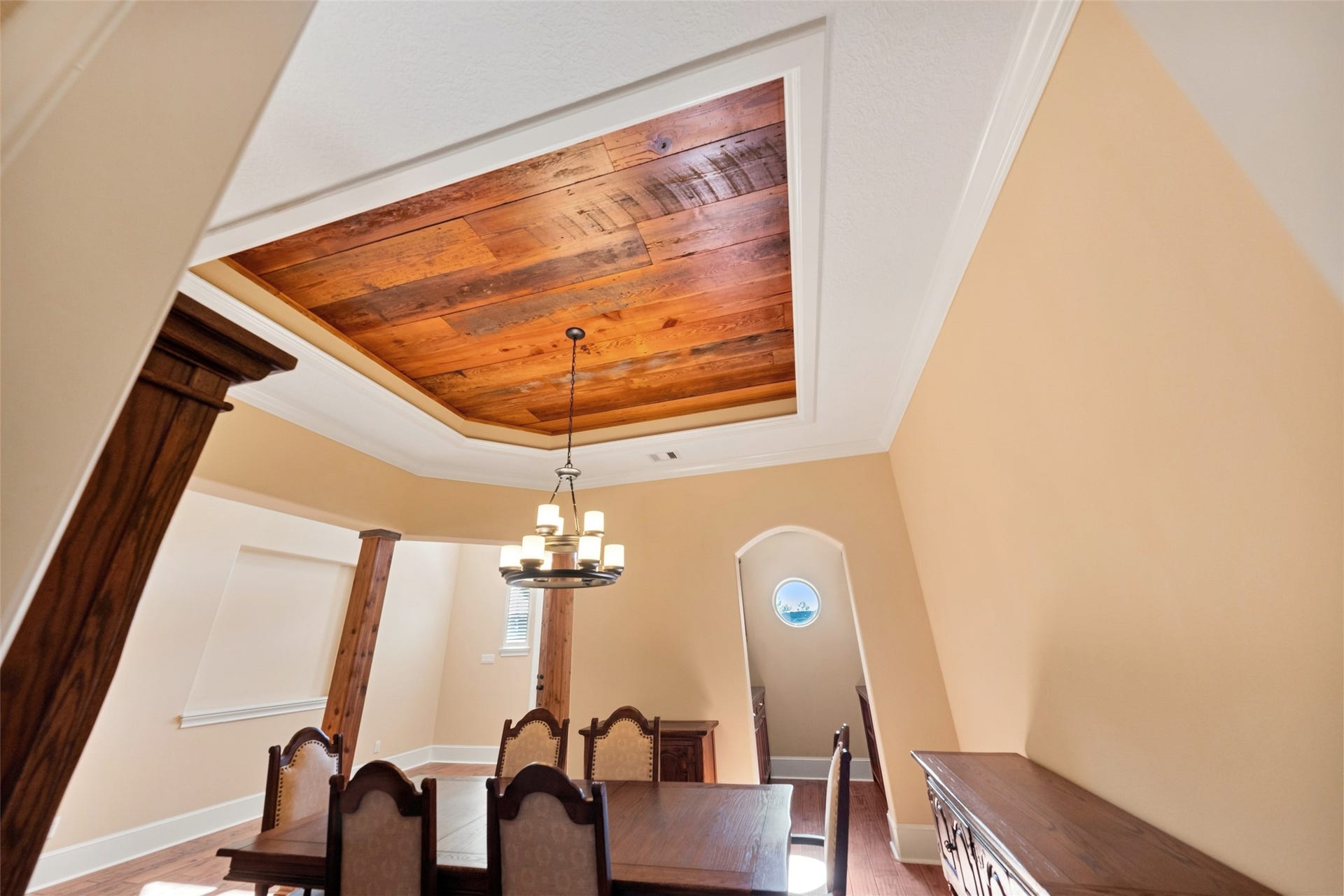 Elegant reclaimed barn wood coffered ceiling adds warmth and sophistication to the dining area.