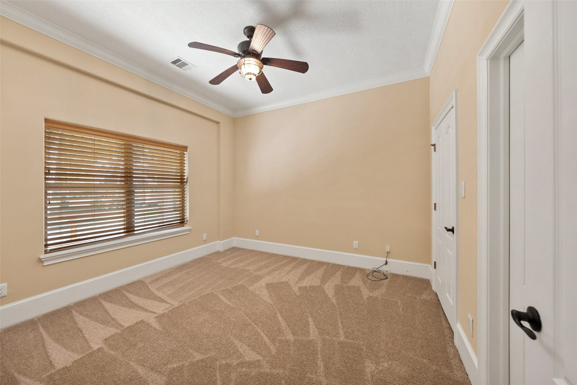 Cozy guesthouse bedroom with brand new carpeting and ample natural light.