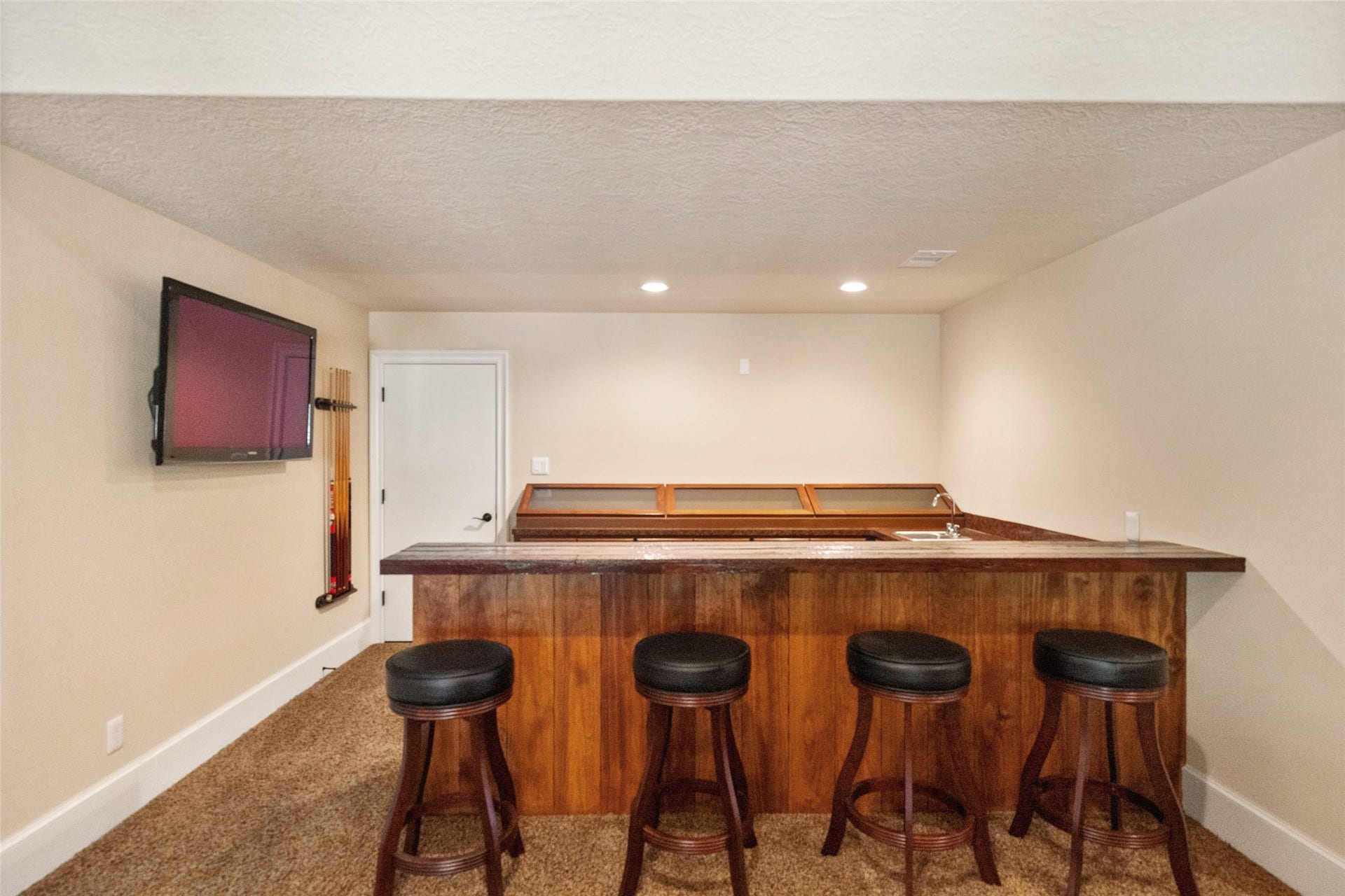 Upstairs game room boasts a custom bar and display center crafted from reclaimed barnwood.
