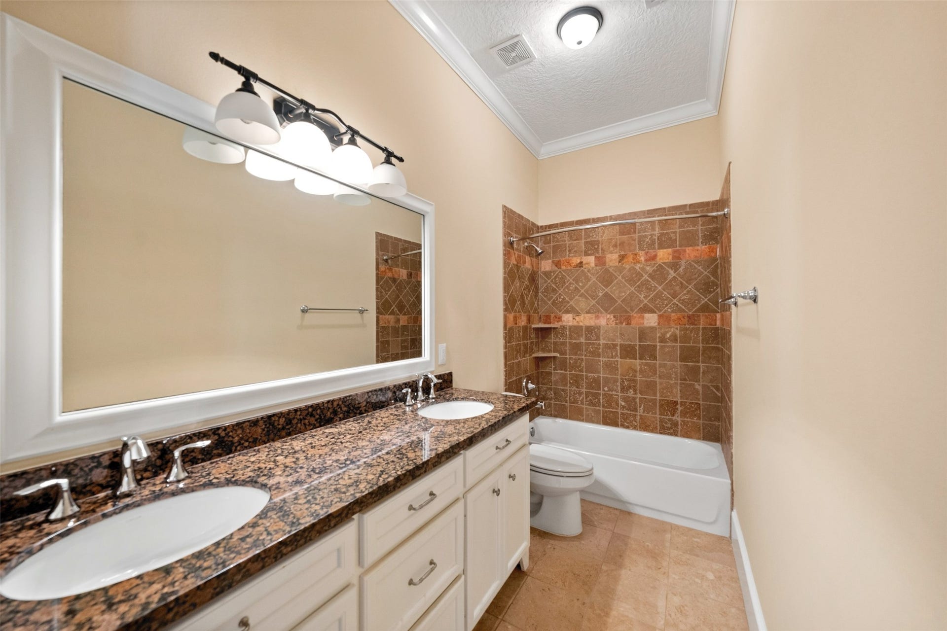 Stylish downstairs guest bath featuring granite dual vanities.