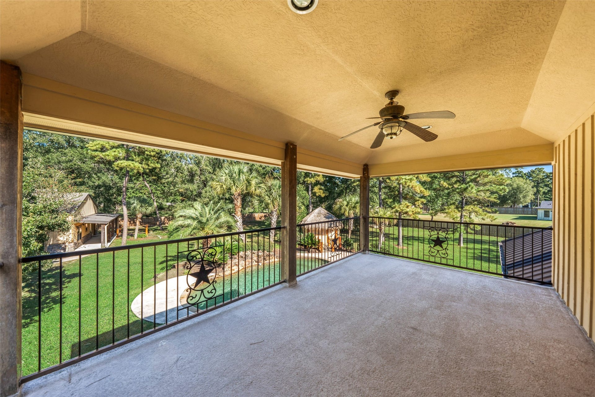 Expansive covered balcony off the game room offers stunning panoramic views of the property.