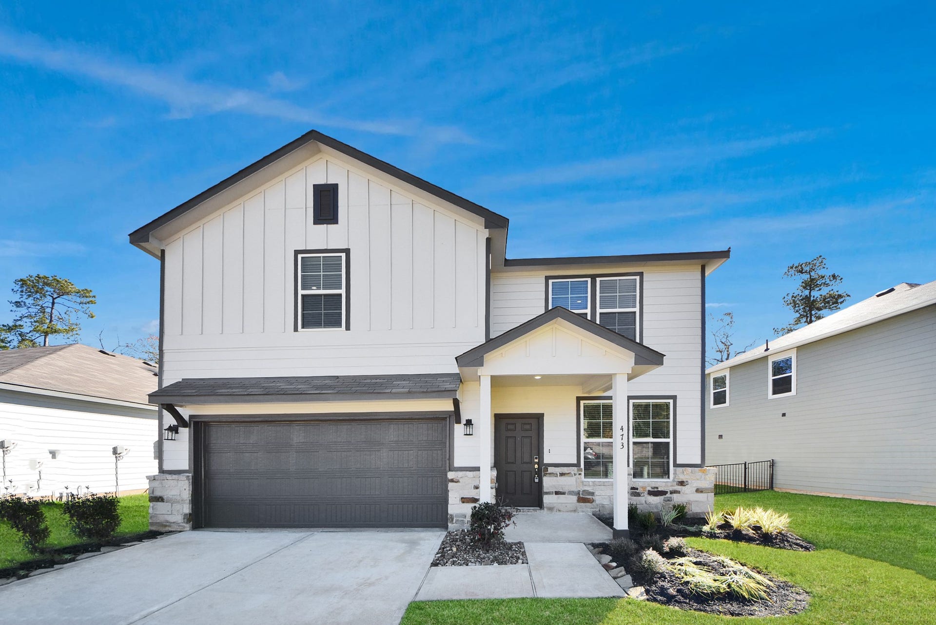 473 Shoreview Drive, Conroe, TX 77303 Welcome Home! Modern two-story home with a welcoming covered porch, elegant siding, and a spacious two-car garage.