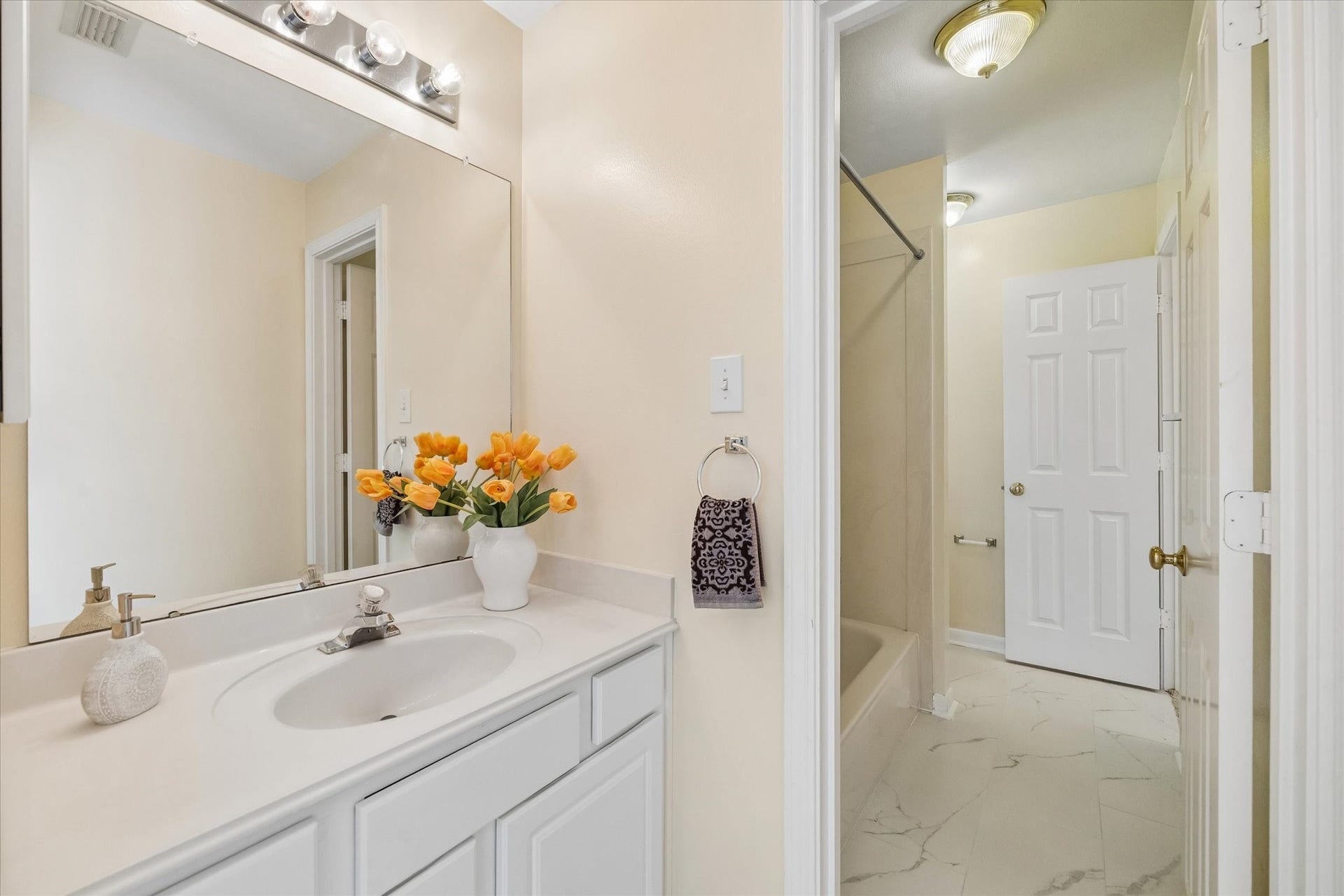 1115 Mulberry Lane, Bellaire, TX 77401 Charming bathroom with sleek white cabinetry, a stylish vanity, and elegant lighting. Enjoy a bright, inviting atmosphere.