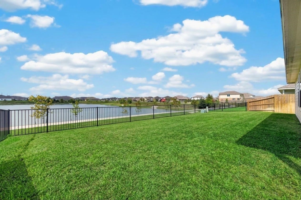 5438 Still Meadow Lane, Richmond, TX 77469 Expansive Waterfront Backyard: A massive, fully fenced lot overlooking the peaceful lake waters. With boundless space for outdoor living, pets, and even a future custom pool, this private oasis is built for ultimate outdoor relaxation.