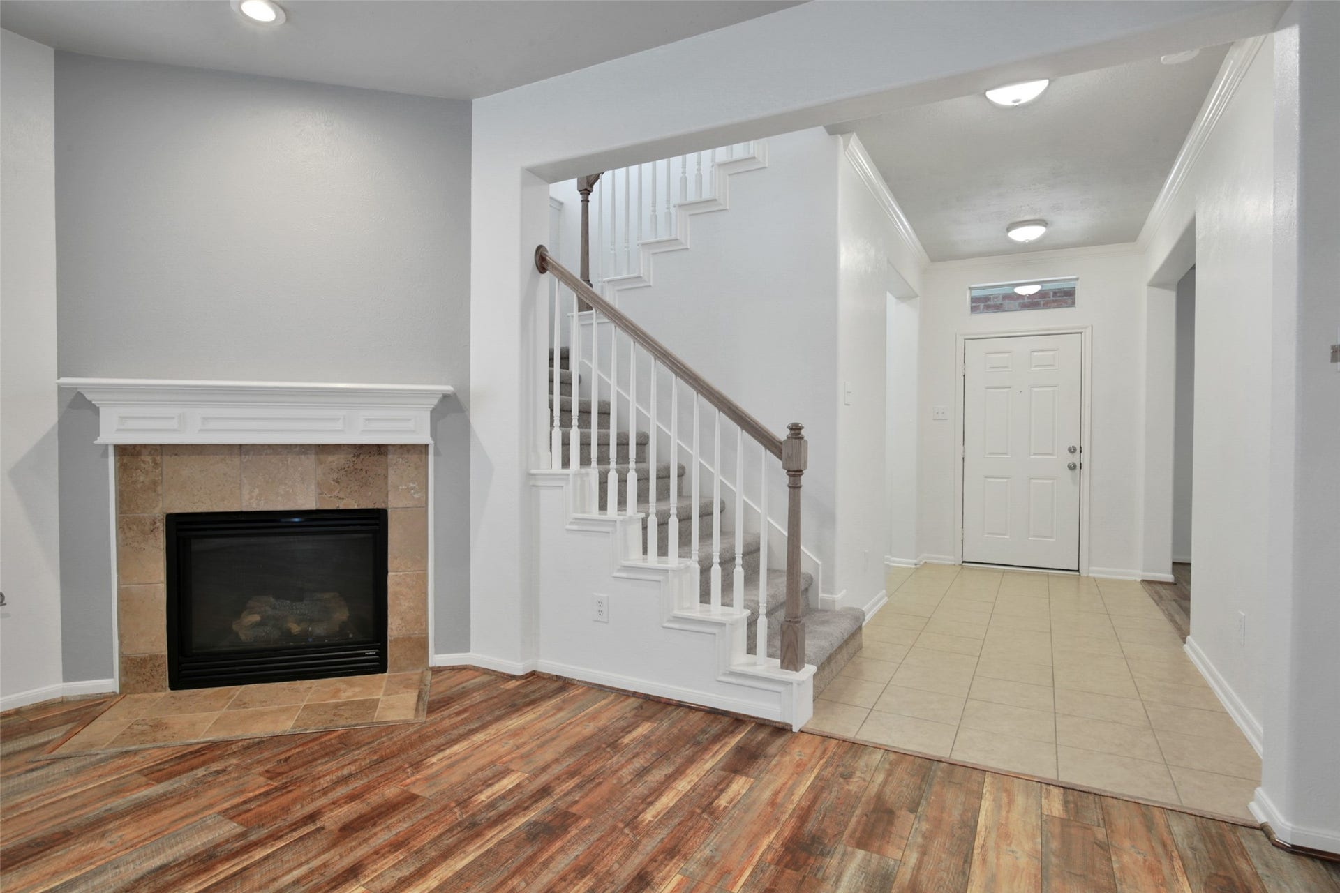 The living room features a gas log fireplace.