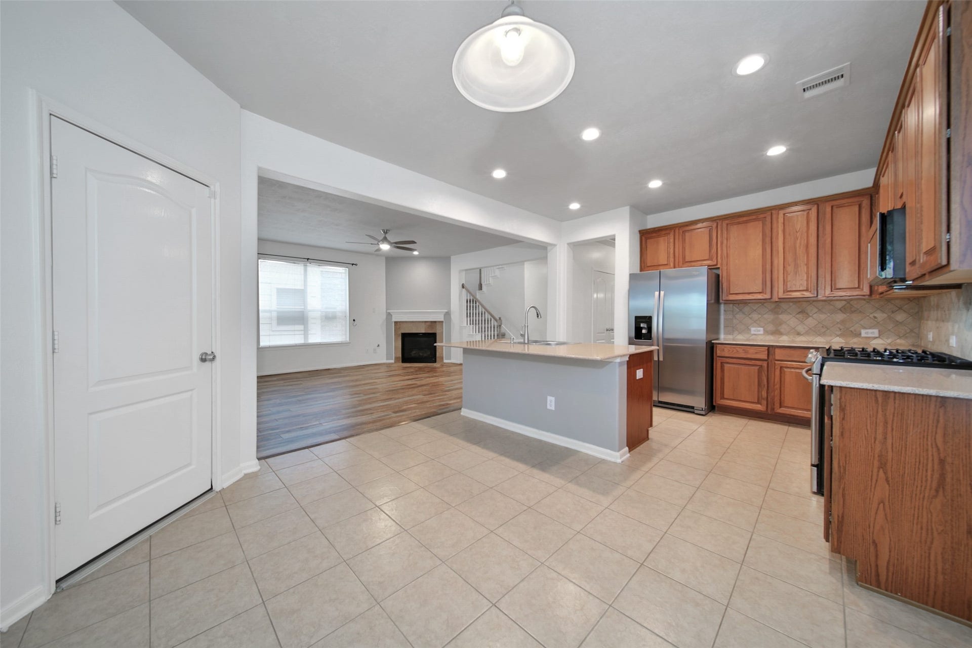 Quartz countertops, Island, breakfast bar, stainless steel appliances, and gas range out fit this kitchen perfectly! Adjacent breakfast nook with patio access.