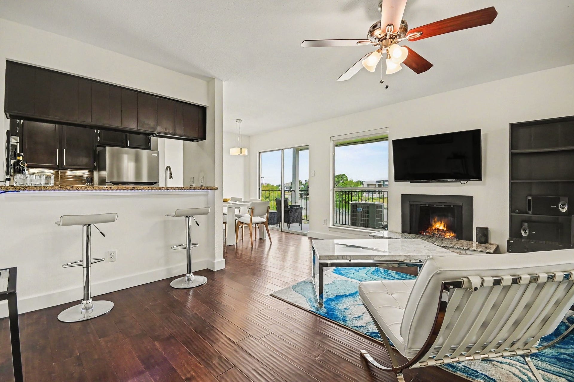 18511 Egret Bay Boulevard, #102, Webster, TX 77058 Living room with fireplace and kitchen connection
