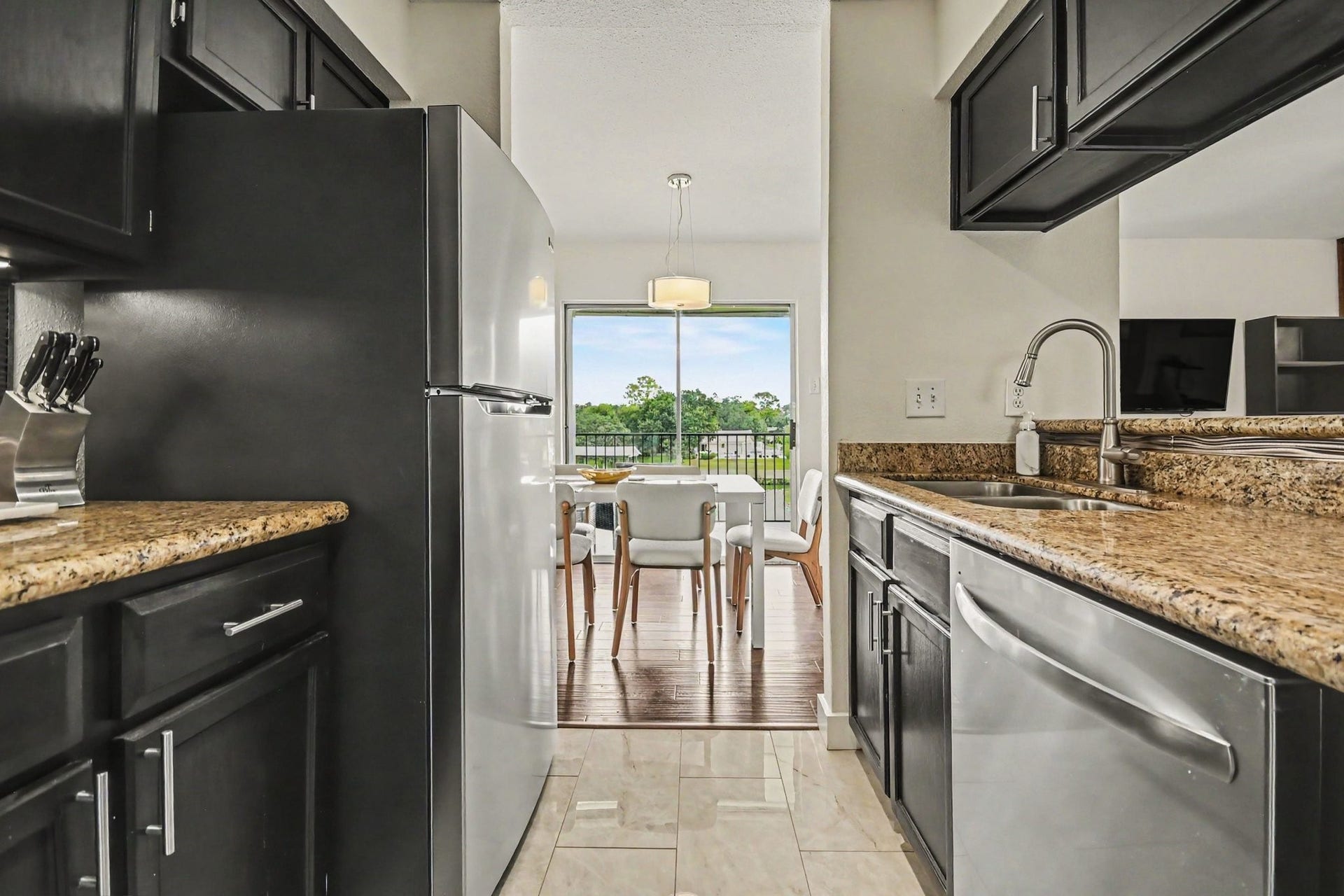 18511 Egret Bay Boulevard, #102, Webster, TX 77058 Kitchen with granite counters and stainless appliances