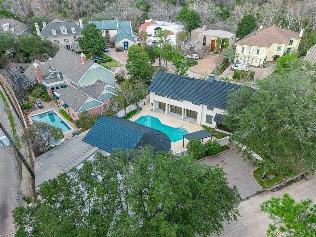 5614 Indian Circle, Houston, TX 77056 Aerial view of a spacious luxury property nestled in a quiet cul-de-sac, showcasing the elegant layout with the main house and guest house flanking a beautifully designed pool.