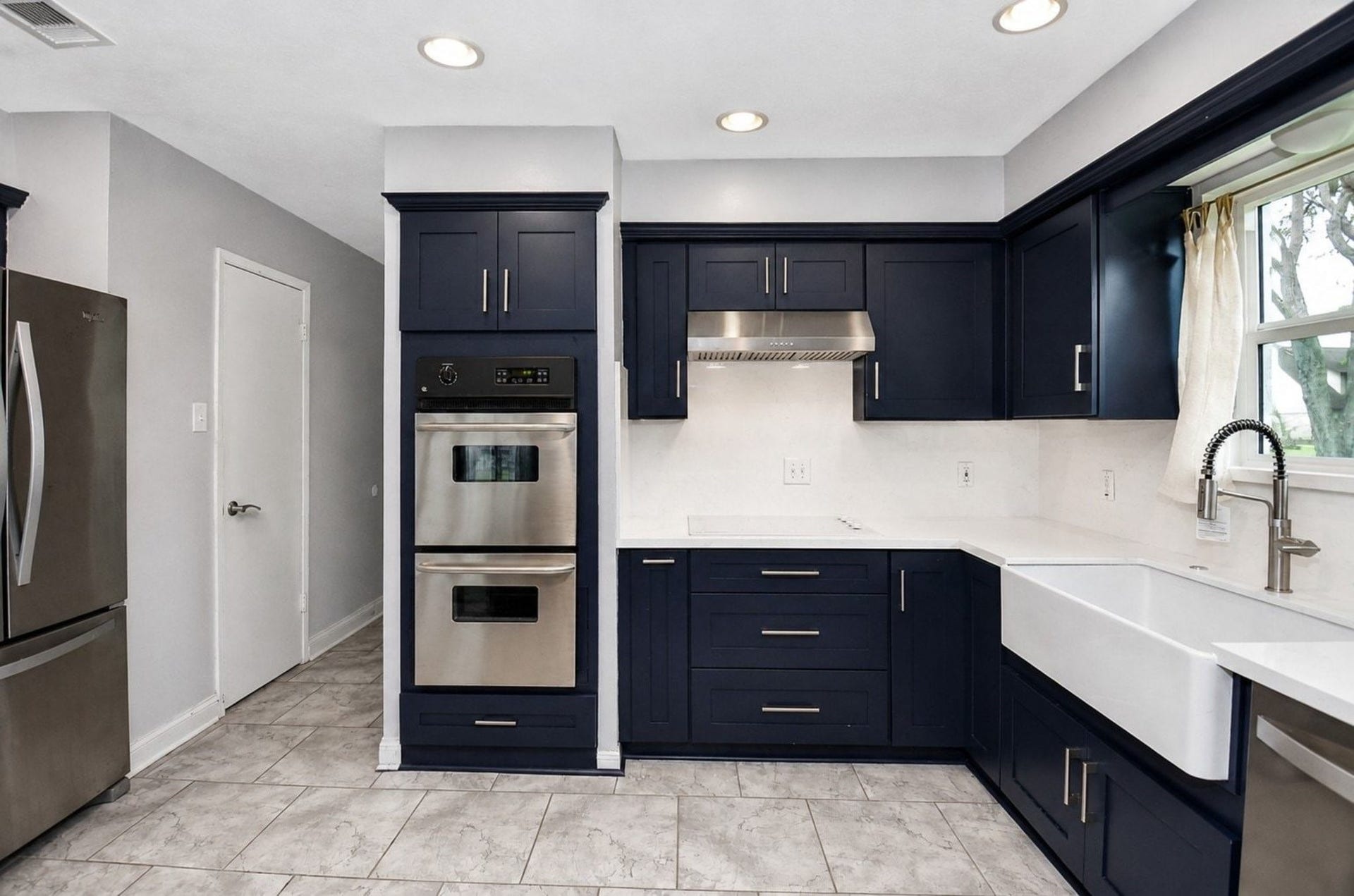 Built-In Double Oven off the White Glass Cooktop and Powerful Vent Hood, Spicy Rack just off the Two Big Pan Drawers, Corner Flexible Cabinet Door.