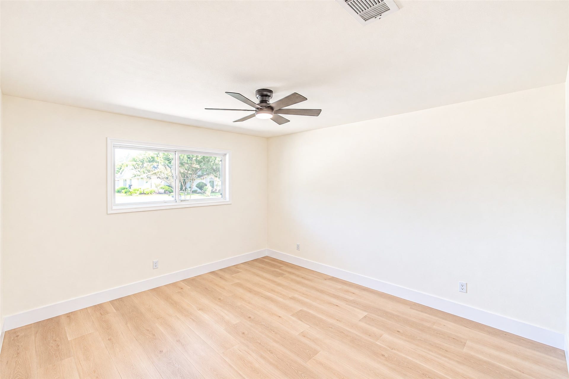 7623 Braes Meadow Drive, Houston, TX 77071 Bedroom 5 offers a spacious, sunlit retreat with luxury vinyl flooring and a modern ceiling fan, perfect for relaxation and comfort.