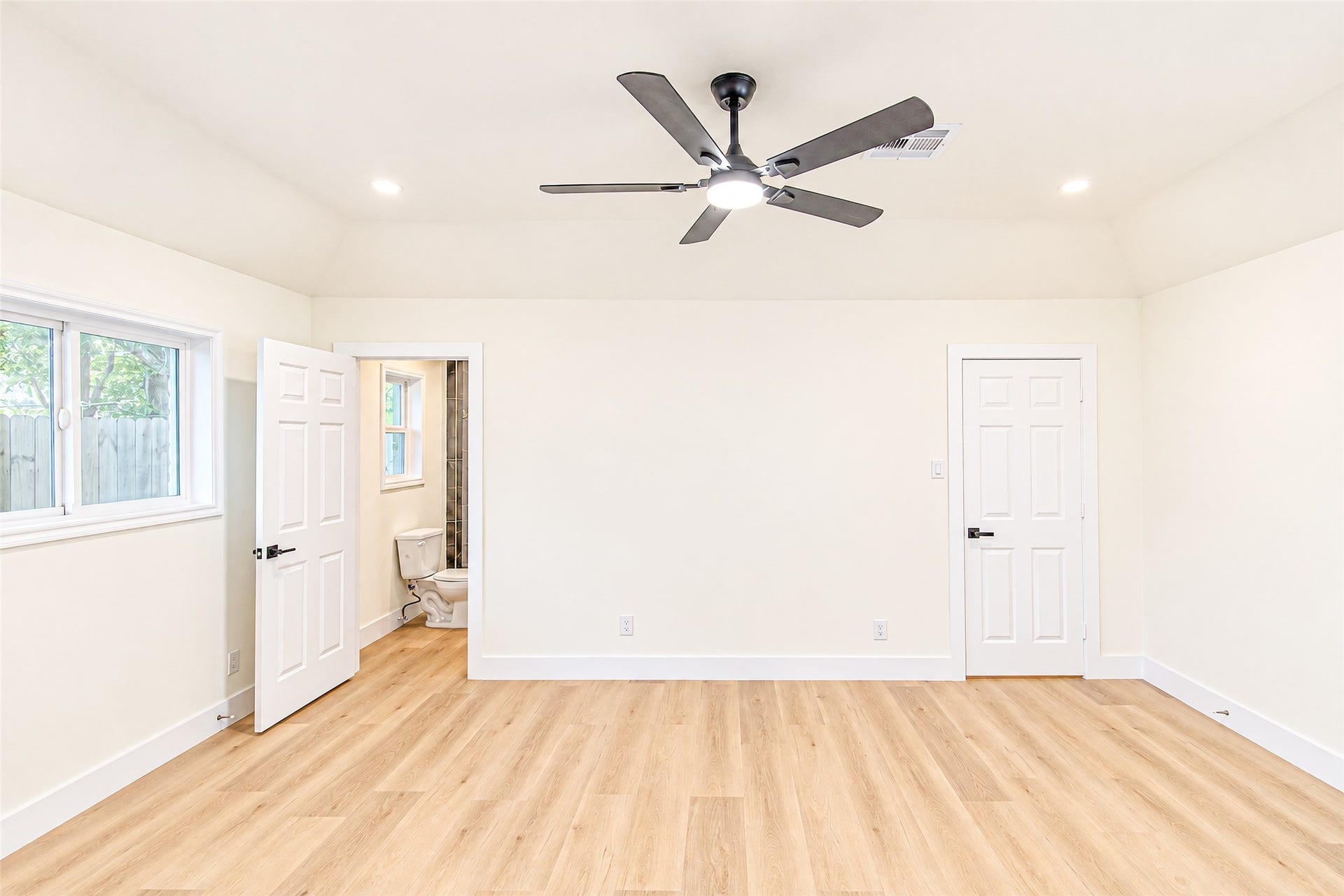 7623 Braes Meadow Drive, Houston, TX 77071 Spacious primary bedroom with luxury vinyl flooring, abundant natural light, and an ensuite bathroom for ultimate comfort.