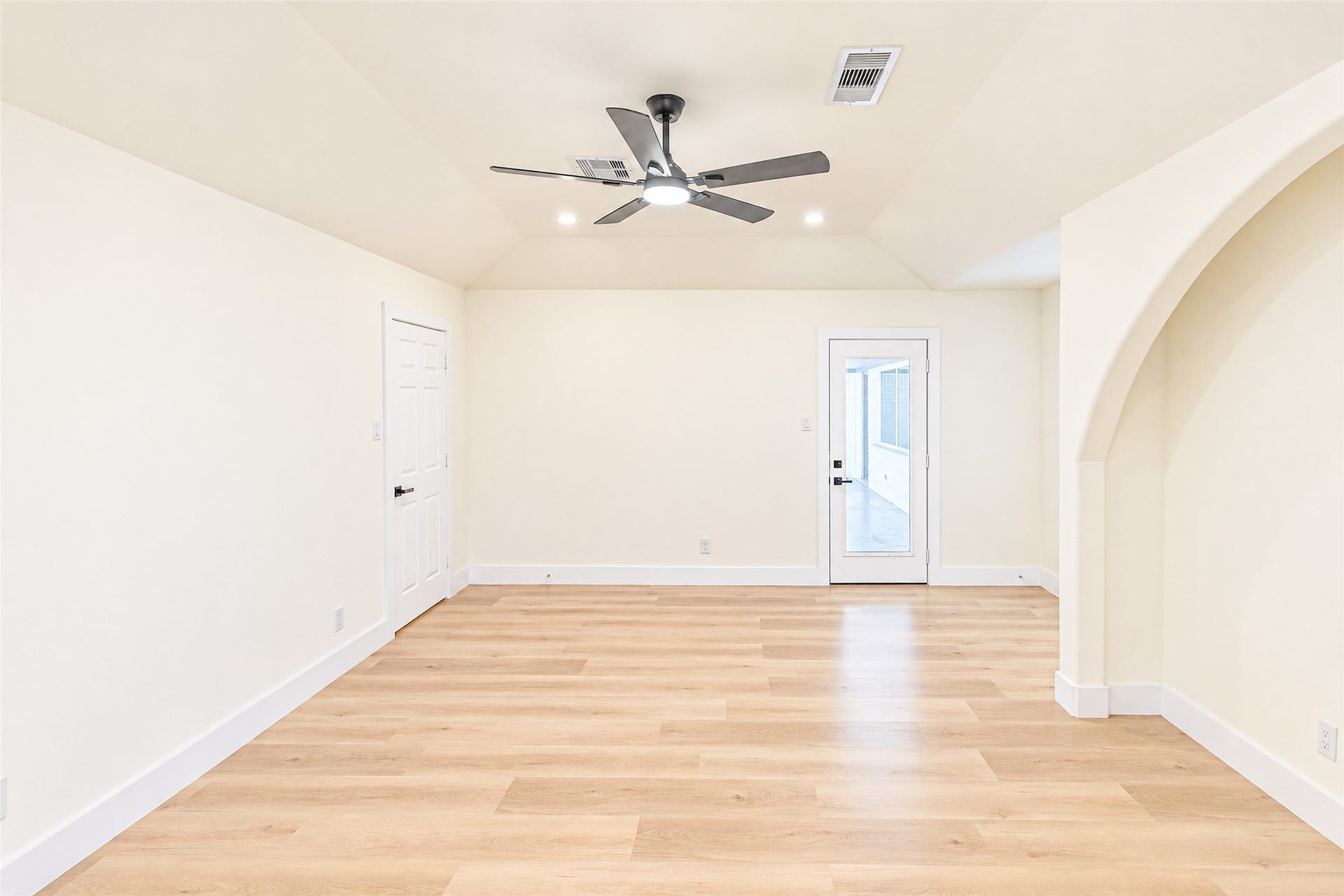 7623 Braes Meadow Drive, Houston, TX 77071 Experience the elegance of this spacious primary bedroom, featuring luxury vinyl flooring, a modern ceiling fan, and abundant natural light through a stylish glass door.