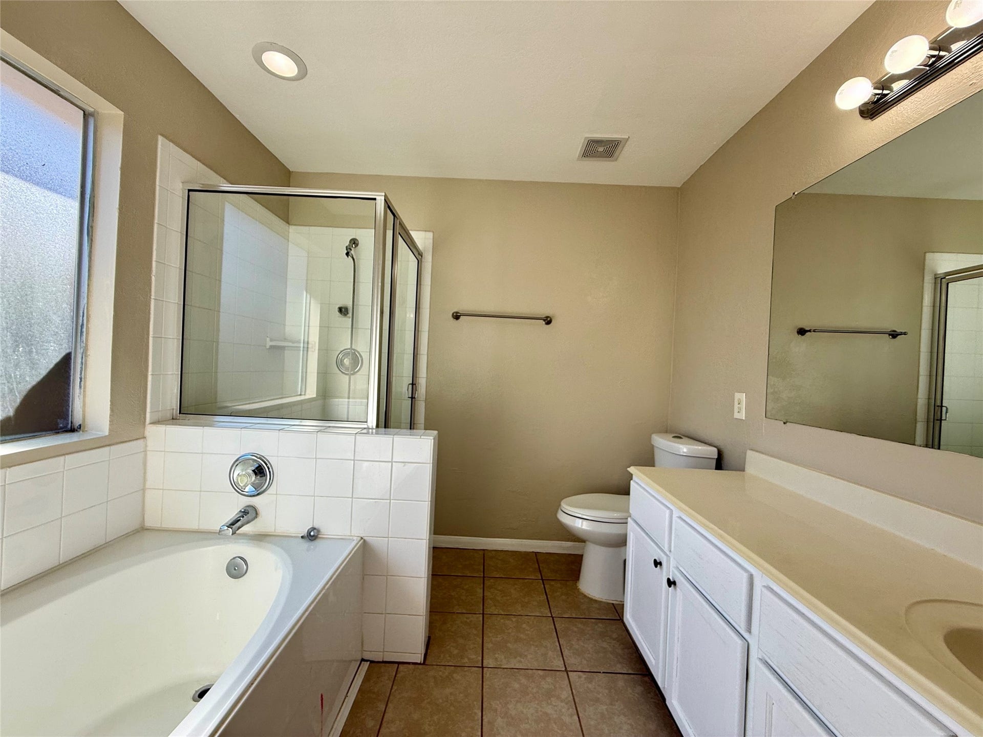 21514 Broadstone Drive, Katy, TX 77449 The primary bathroom has a separate shower and soaking tub.