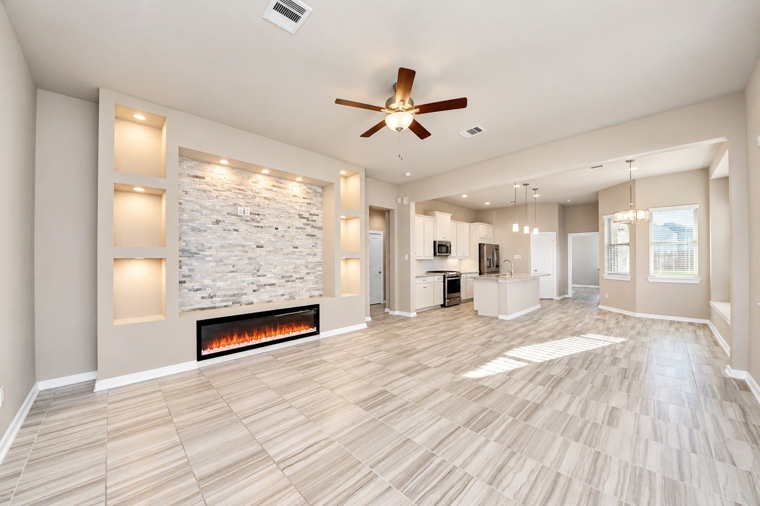 6110 Dovetail Cliff Court, Katy, TX 77493 Open living and dining areas featuring beautiful tile flooring, recessed lighting, and a modern electric fireplace.