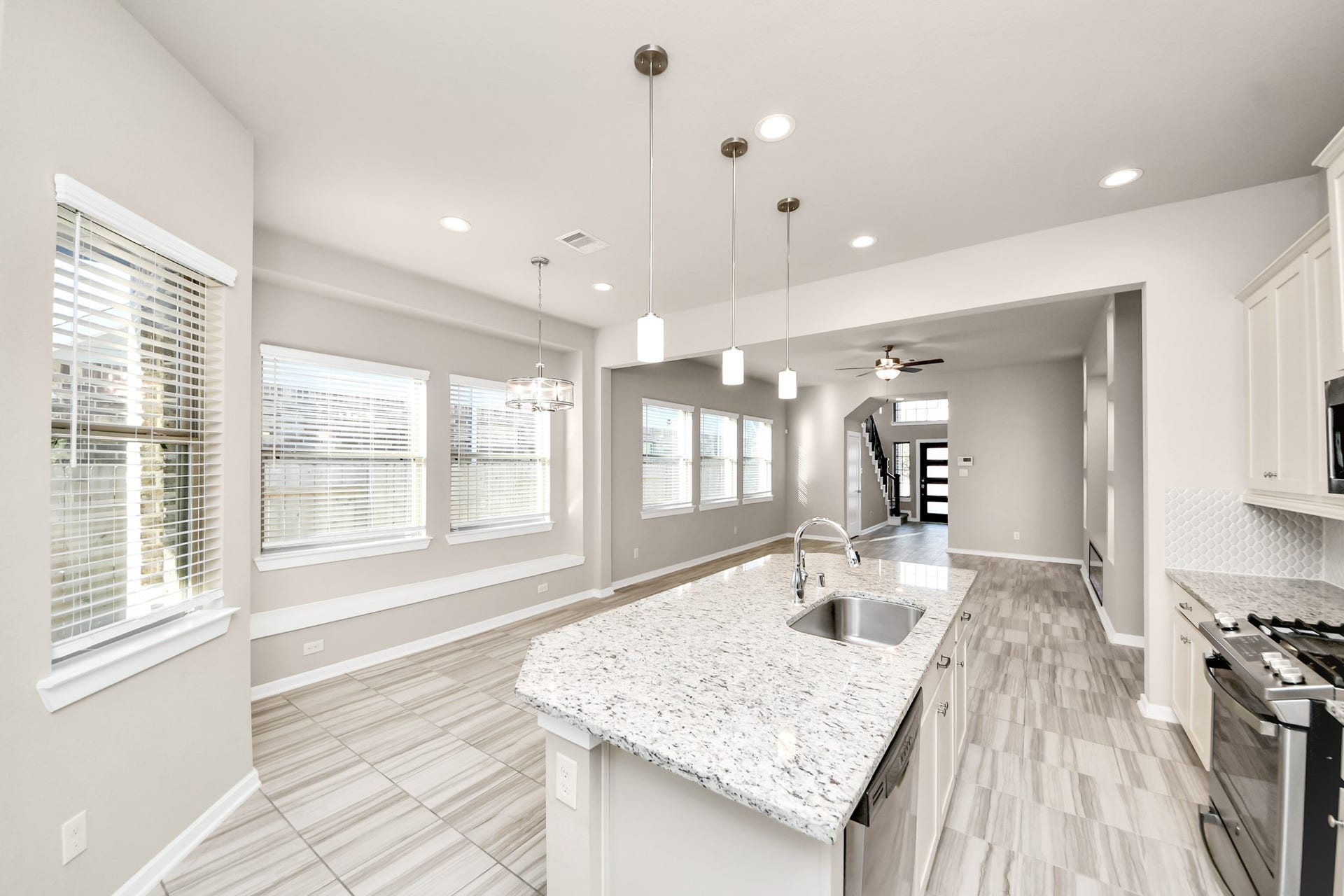6110 Dovetail Cliff Court, Katy, TX 77493 Bright and inviting kitchen featuring a large center island, ample cabinetry, and stainless steel appliances.