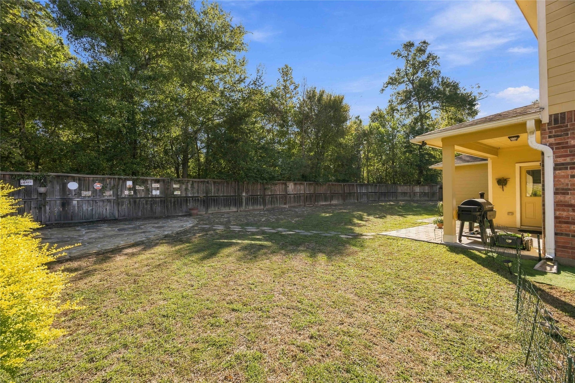 3152 Copeland Bend, Conroe, TX 77301 Picture slow mornings or evening gatherings on the covered patio, overlooking the lawn and tree line.