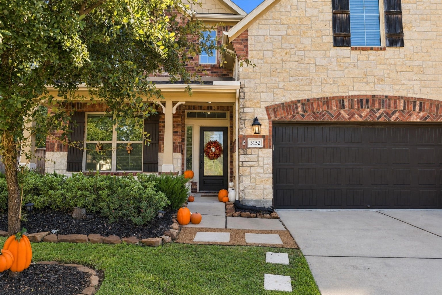3152 Copeland Bend, Conroe, TX 77301 A covered entry framed by manicured landscaping makes coming home feel like an occasion.