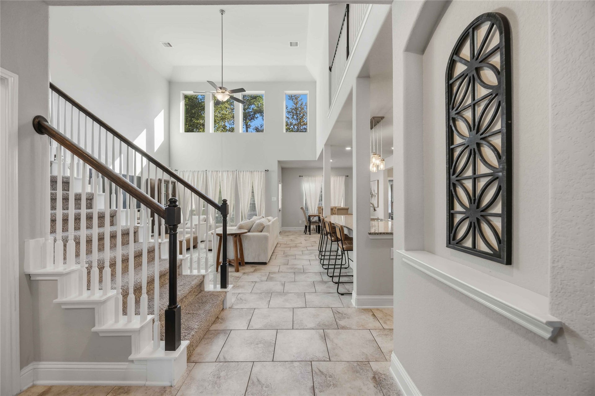 3152 Copeland Bend, Conroe, TX 77301 White balusters and a decorative iron accent give the staircase a touch of character.