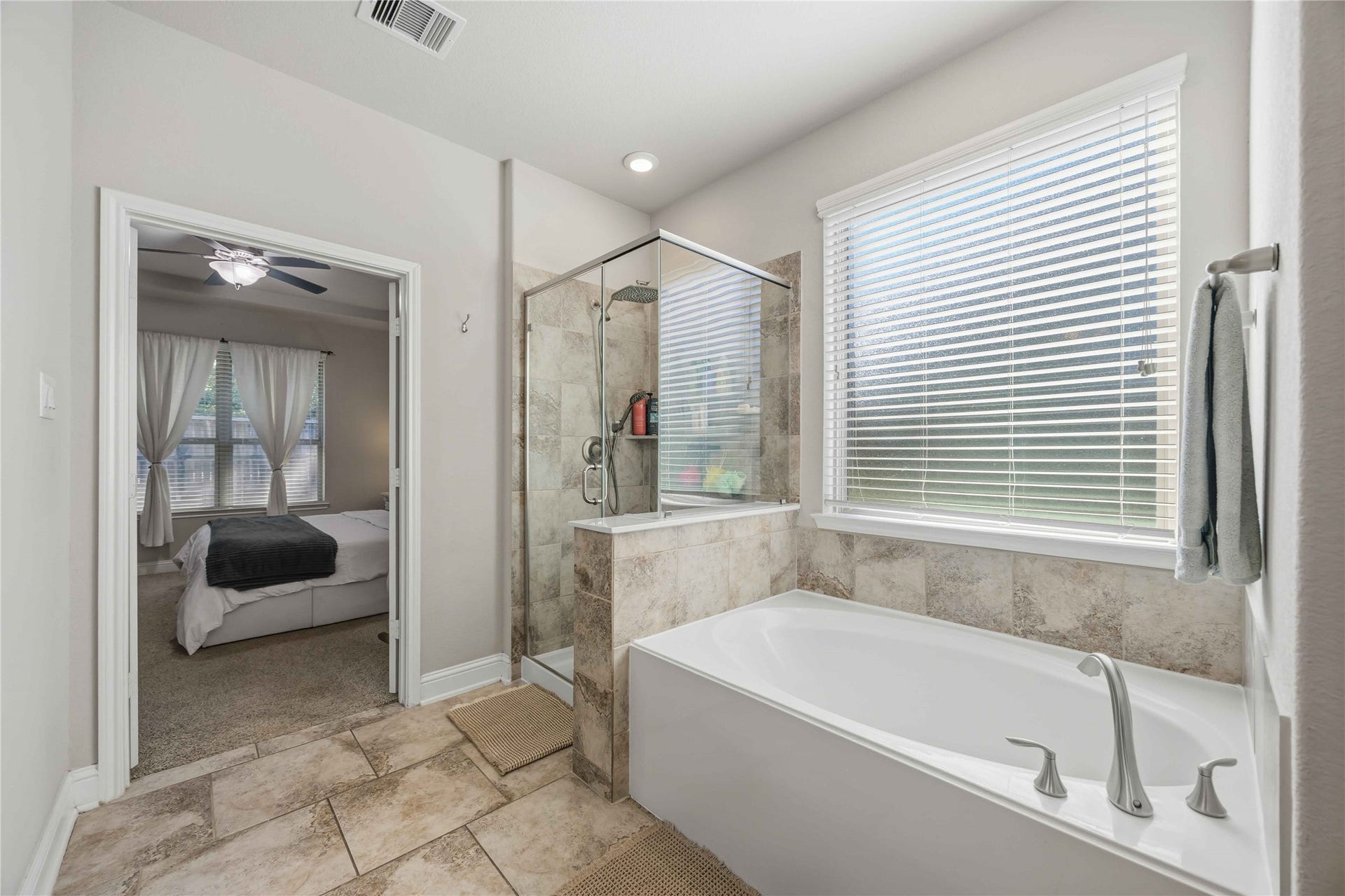 3152 Copeland Bend, Conroe, TX 77301 A soaking tub beneath the window sets the scene for slow, relaxing evenings.