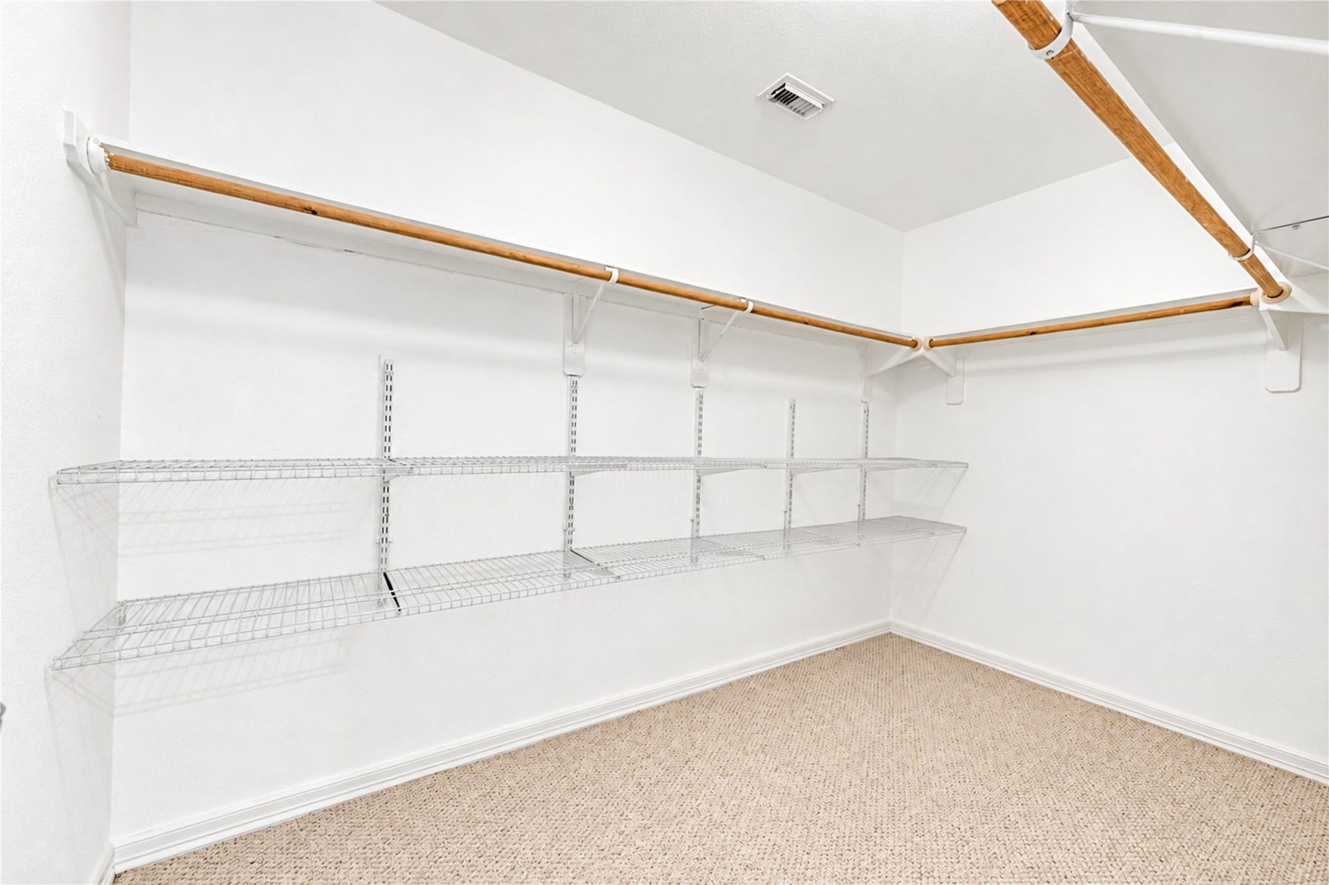 20910 Trenton Valley Lane, Katy, TX 77449 Oversized walk in closet with extensive hanging space and built in shelving for exceptional storage and organization.