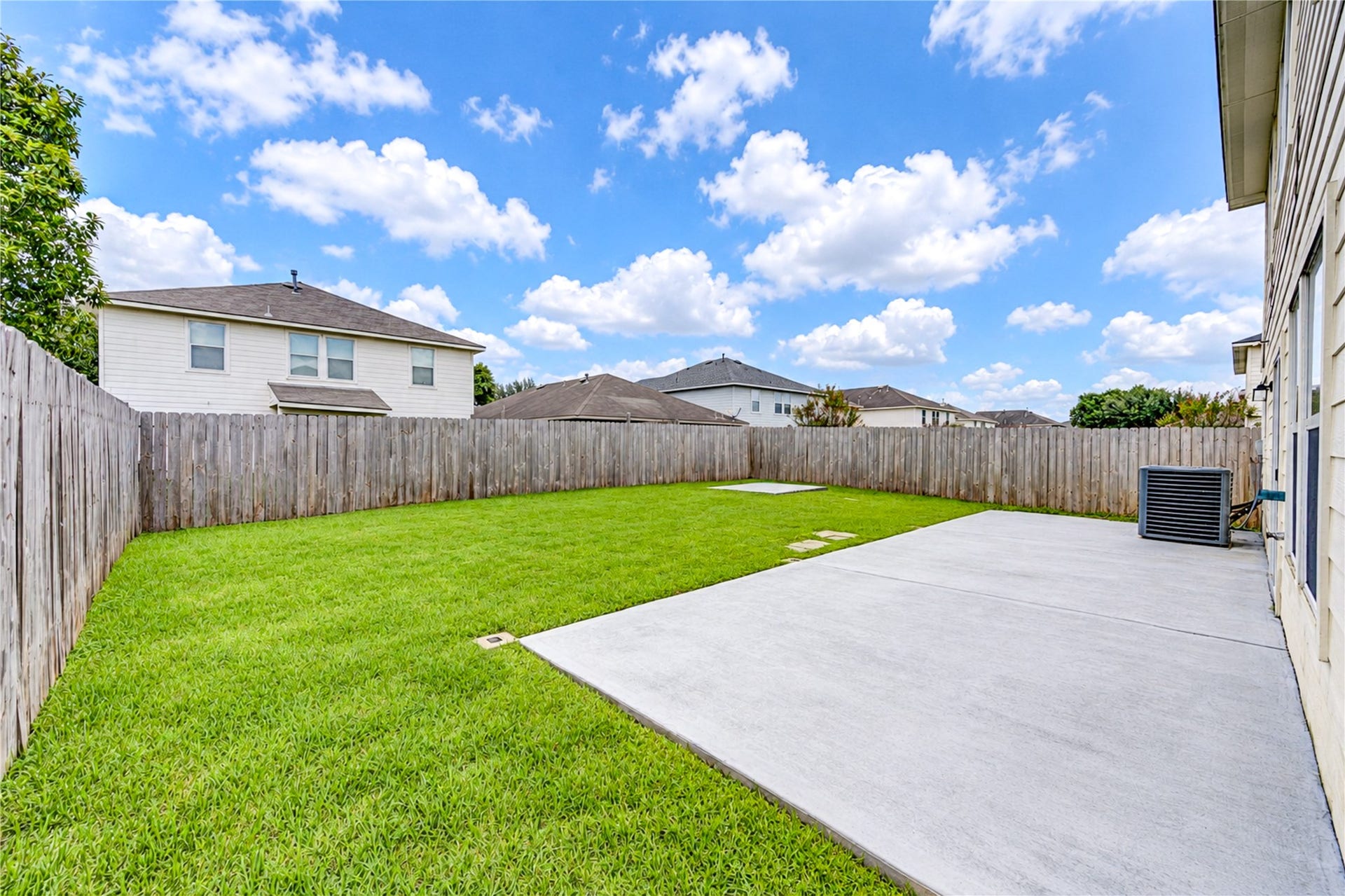 20910 Trenton Valley Lane, Katy, TX 77449 extended concrete patio and plenty of green space for outdoor entertaining, play, or pets.