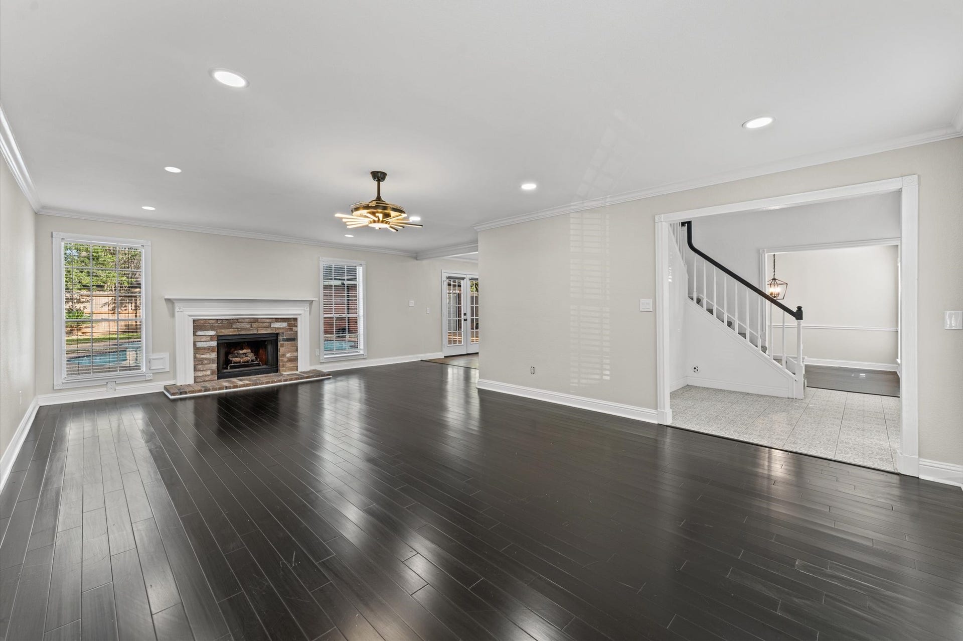 1118 Cheyenne Meadows Drive, Katy, TX 77450 The first-floor Living Room features a wood-burning fireplace and windows overlooking the backyard pool.