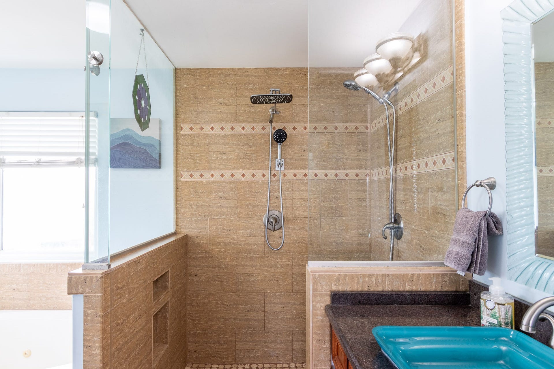 2414 Avenue P, San Leon, TX 77539 Primary ensuite bathroom with dual shower heads. Glass vessel sinks