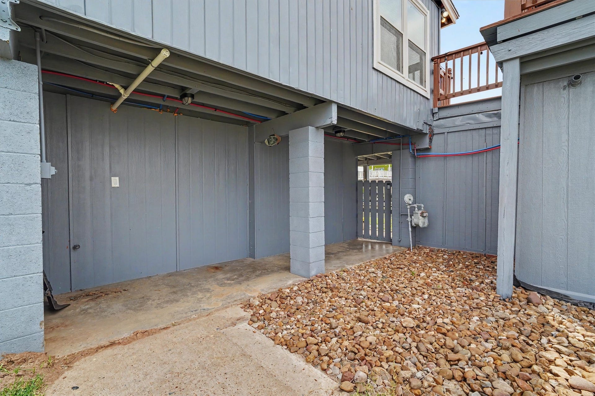370 Ling Street, Bayou Vista, TX 77563 Side yard with rock landscape and gate to the water side of the home