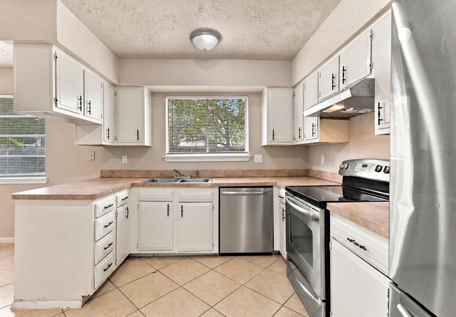 4426 Burkegate Drive, Spring, TX 77373 Kitchen comes with all new appliances. Virtually staged with stainless steal dishwasher.