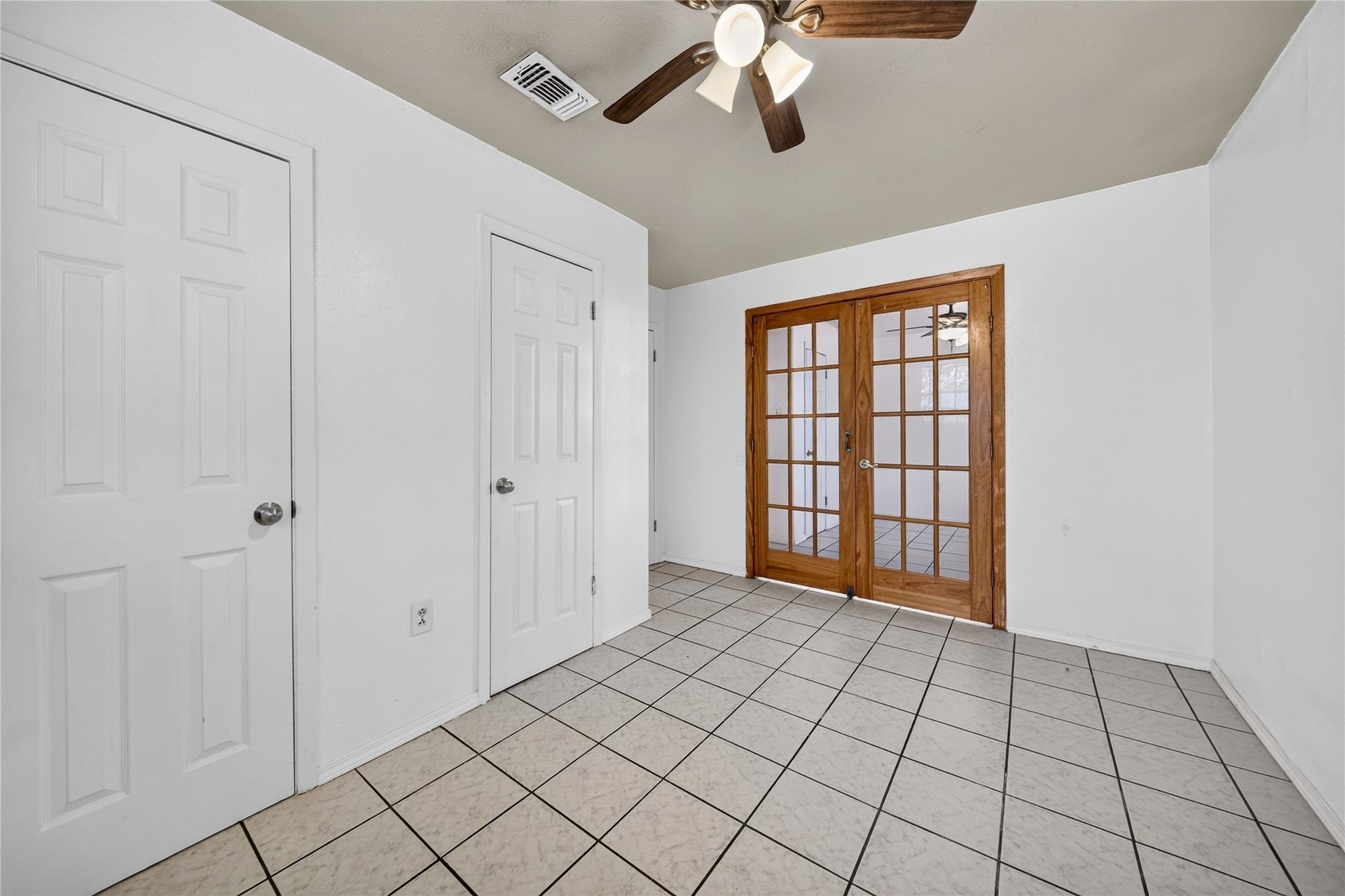 522 Hollyvale Dr, Houston, TX 77060 Spacious bedroom with ample storage and French-door access.