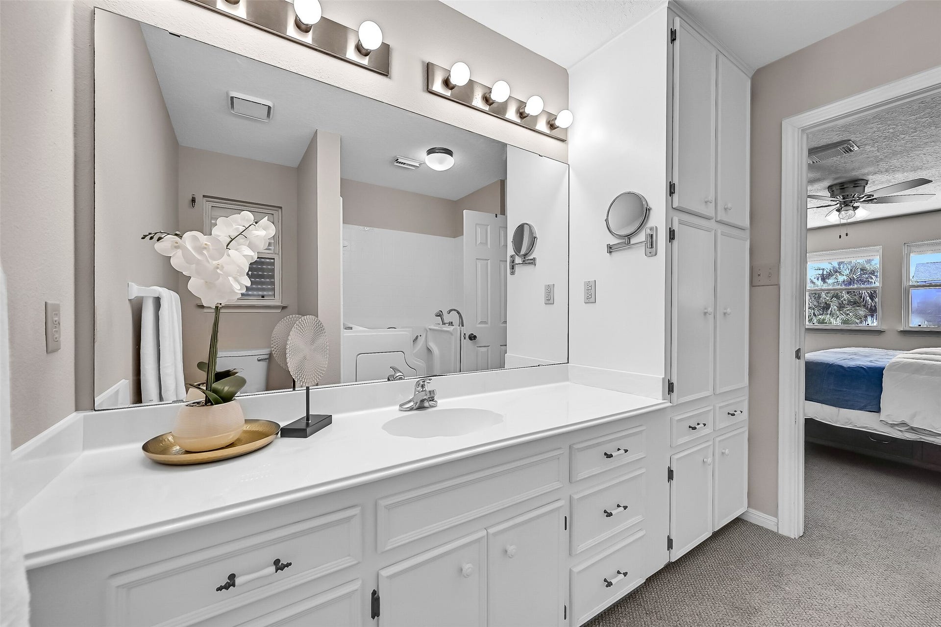 243 Isles End Road, #RR2, Tiki Island, TX 77554 The ensuite bath features a large vanity with extensive storage, built-in cabinetry, and plenty of counter space. Neutral finishes and a functional layout provide a clean, comfortable space to begin and end each day.