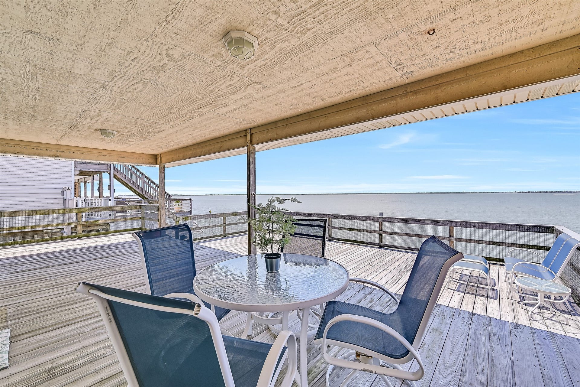 243 Isles End Road, #RR2, Tiki Island, TX 77554 Step outside to an expansive covered deck overlooking Jones Bay, where cooling coastal breezes and panoramic water views create the perfect backdrop for morning coffee, afternoon relaxation, and unforgettable sunsets. With a coveted west-facing orientation, this outdoor retreat delivers front-row seats to the vibrant evening skies that make Tiki Island living so special.