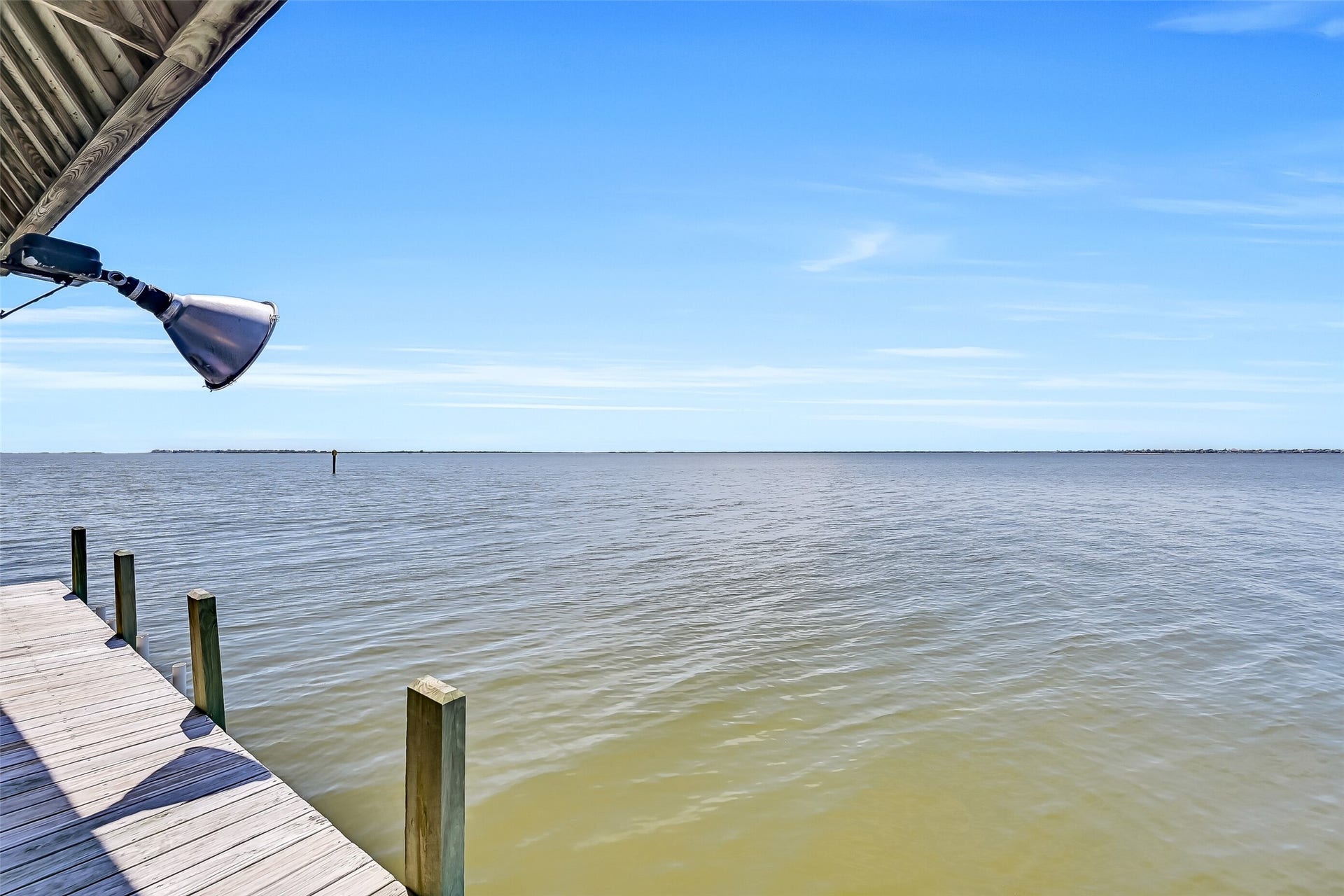243 Isles End Road, #RR2, Tiki Island, TX 77554 Waterfront living reaches its peak here. The dock is equipped with fishing lights that attract baitfish after dark, creating excellent opportunities to catch speckled trout, redfish, flounder, and black drum right from your own property. Combined with sweeping west-facing views across Jones Bay toward West Bay, it's the perfect place to spend evenings watching boats drift by and sunsets light up the horizon.